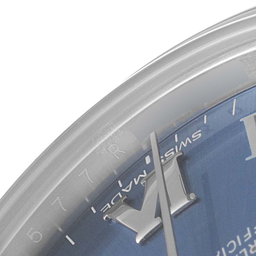 The image shows a close-up of the edge of the dial and the hour hand of a Rolex Mid-Size 177200 Women's Stainless Steel Blue Dial 177200 Women's Stainless Steel Blue Dial watch, highlighting the "Swiss Made" text.