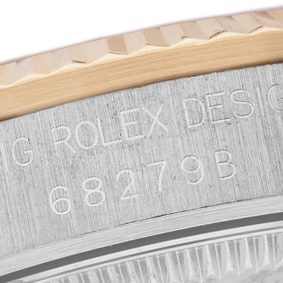 This image shows a close-up of the side case of a Rolex President 68279 Women's White Gold Champagne Dial 68279 Women's White Gold Champagne Dial model watch, highlighting the engraved model information and part of the bezel.