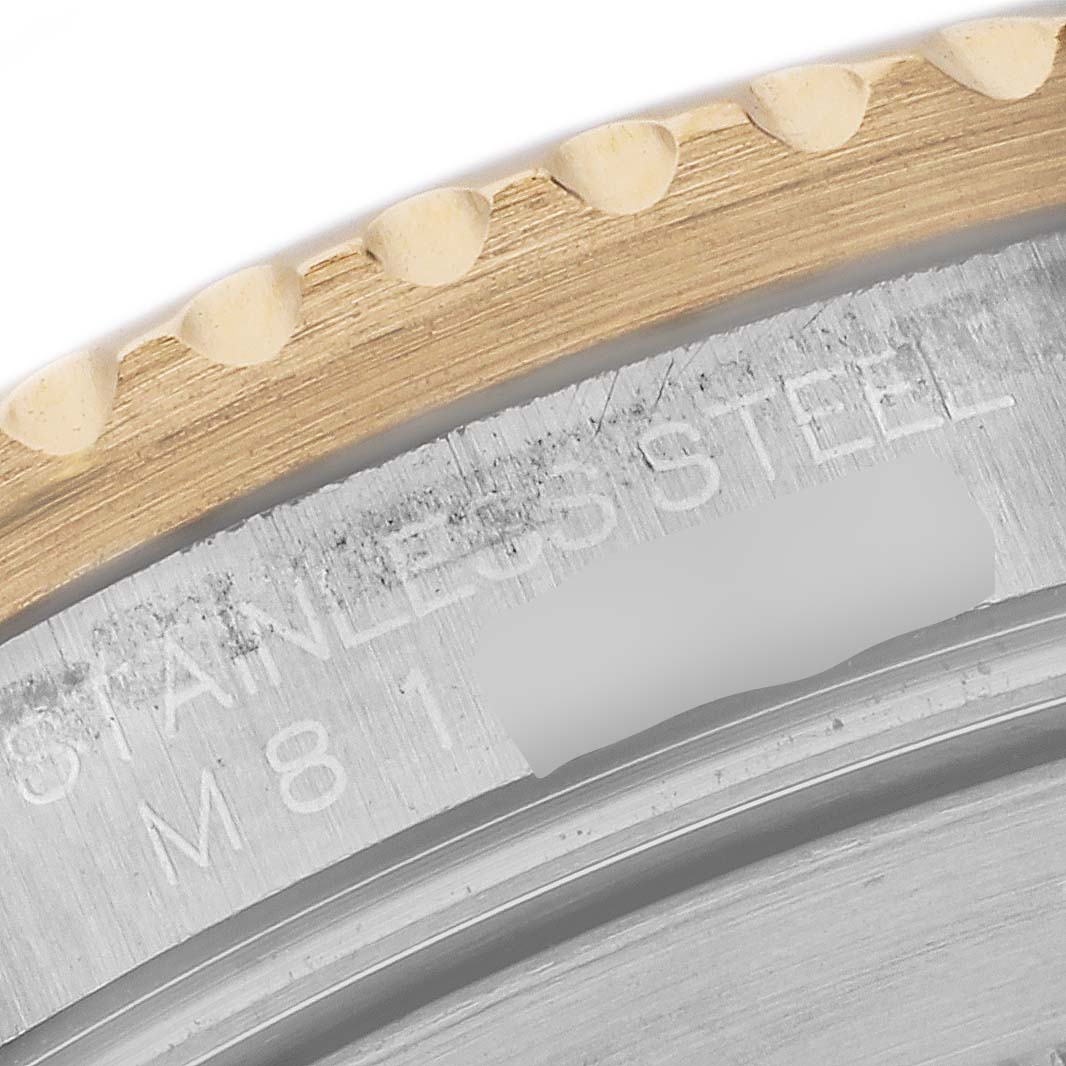 The image shows a close-up of the bezel and case back edge of a Rolex Submariner 16613 Men's Steel and Gold (two tone) Blue Dial 16613 Men's Steel and Gold (two tone) Blue Dial watch, highlighting the “STAINLESS STEEL” engraving.
