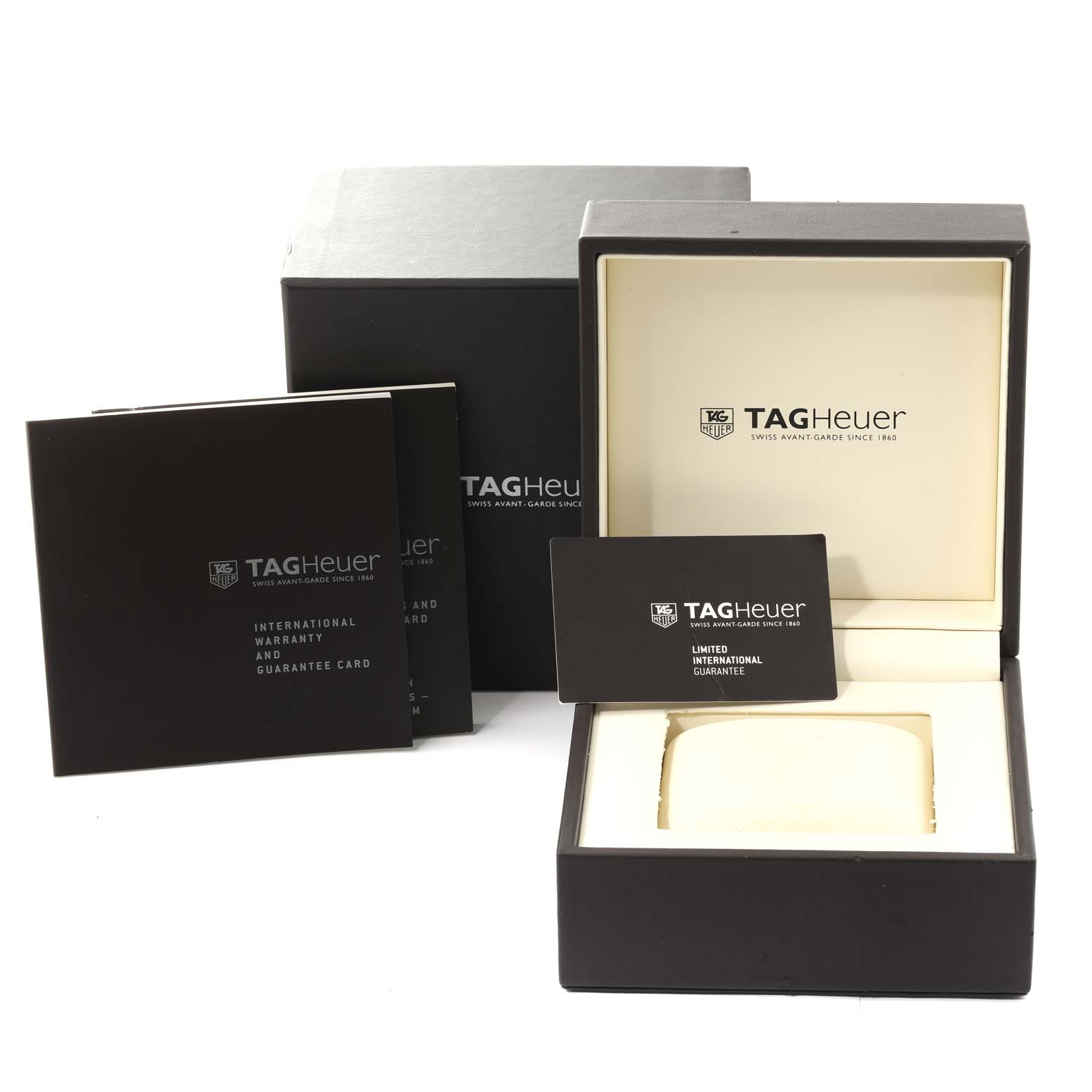 The image shows the packaging, warranty cards, and inner box for the Monaco model by Tag Heuer.