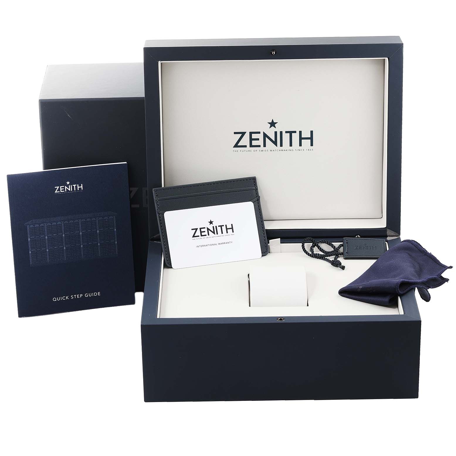 The image shows the accessory set of a Zenith Chronomaster 03.3100.3600 Men's Stainless Steel Black Dial 03.3100.3600 Men's Stainless Steel Black Dial watch, including the box, quick step guide, warranty card, tag, and cleaning cloth.
