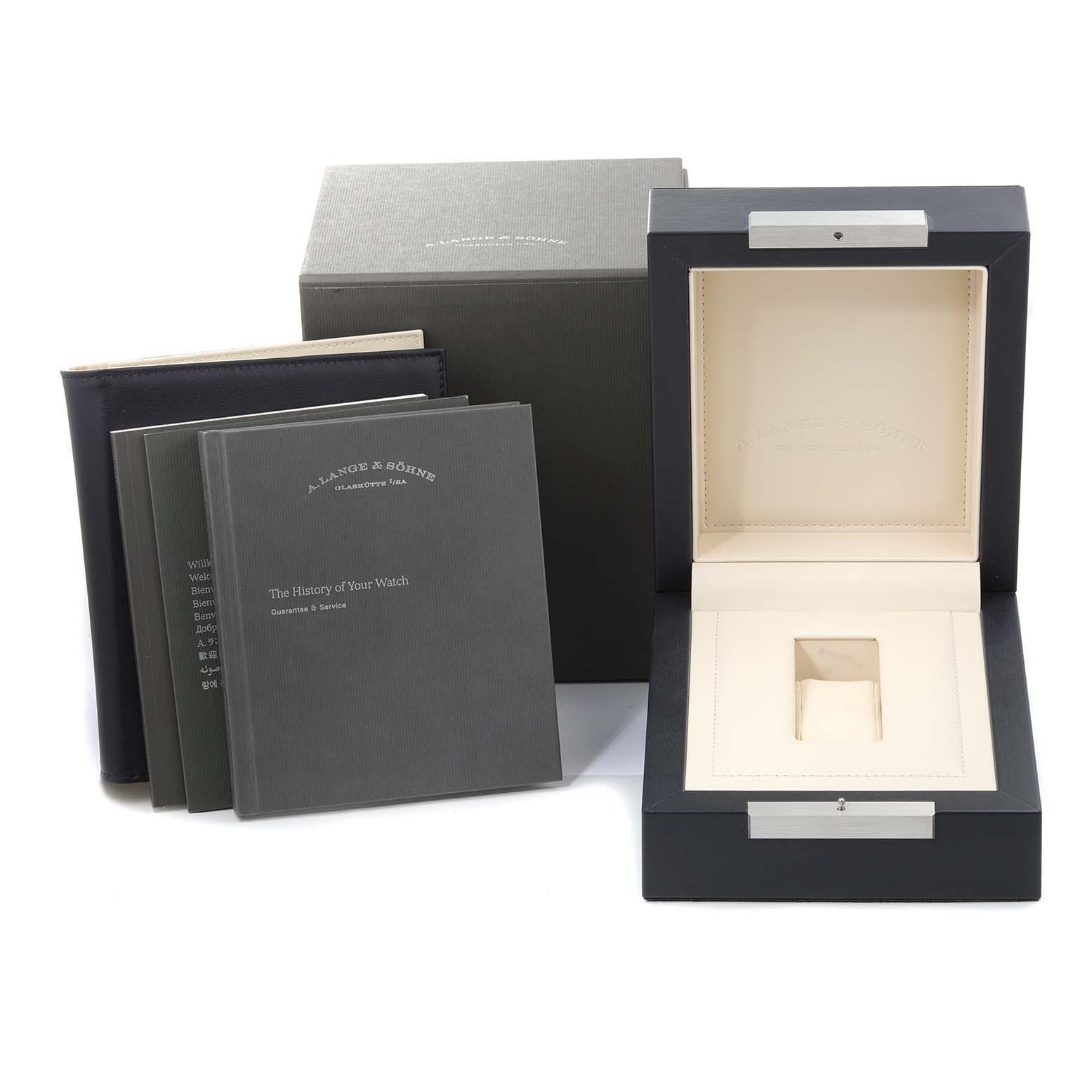 The image shows an open presentation box with manuals for the Lange 1 model by A. Lange & Söhne.