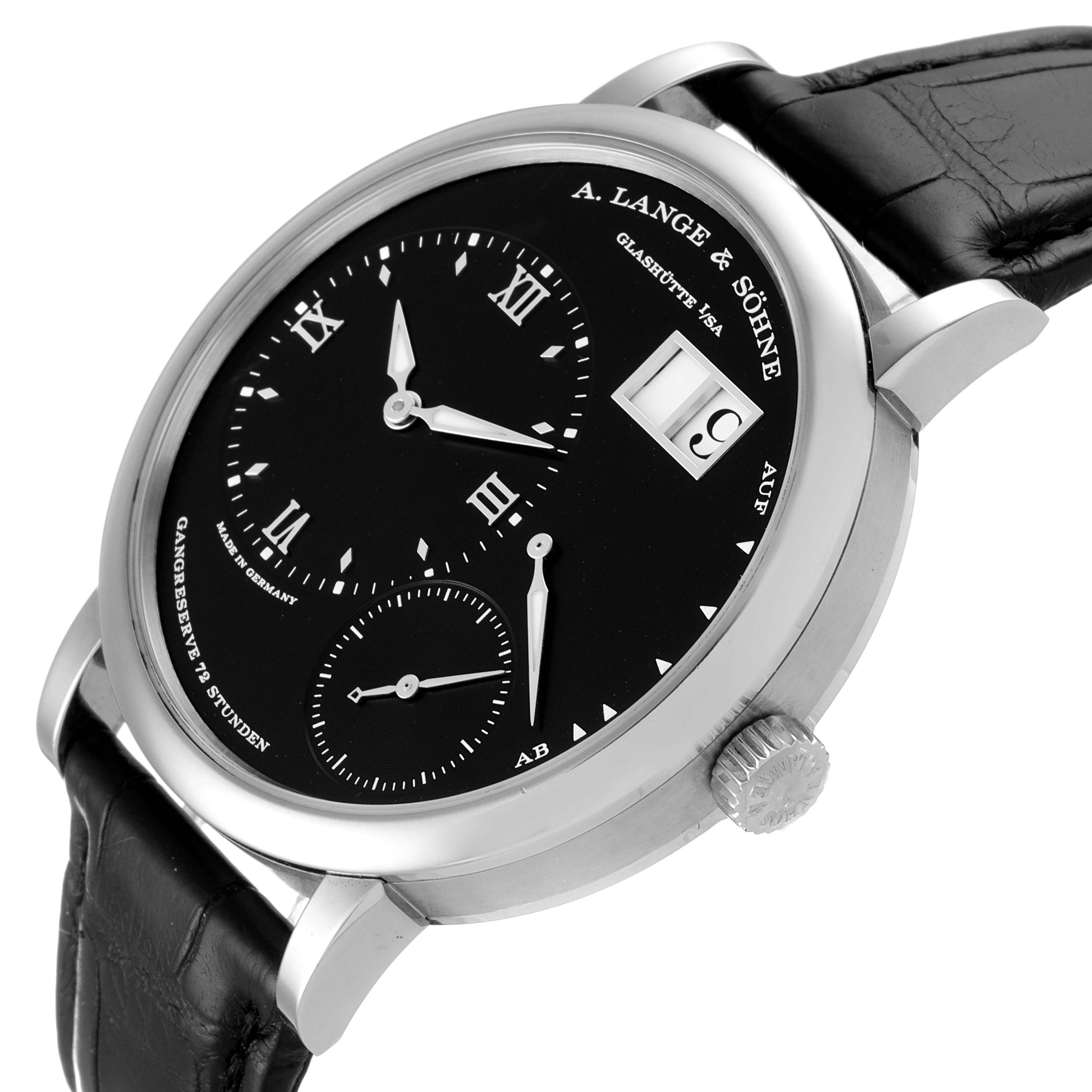The image shows a side-angle view of an A. Lange & Sohne Lange 1 117.028 Men's White Gold Black Dial watch, featuring its dial, crown, and black leather strap.