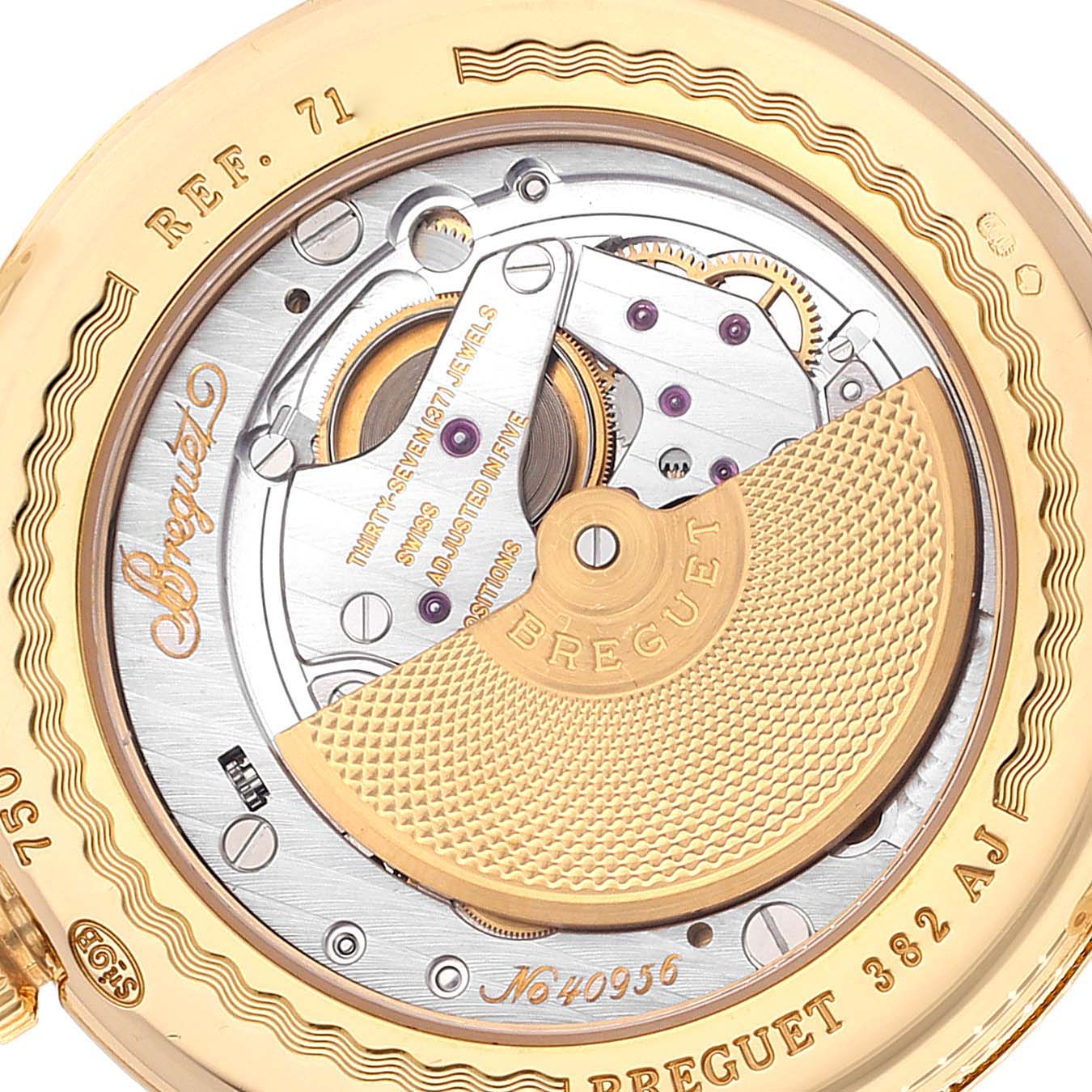The image shows the back view of a Breguet Classique 7137BA/11/9V6 Men
s Yellow Gold Silver Dial 7137BA/11/9V6 Men
s Yellow Gold Silver Dial watch, highlighting its intricate mechanical movement and inscriptions.