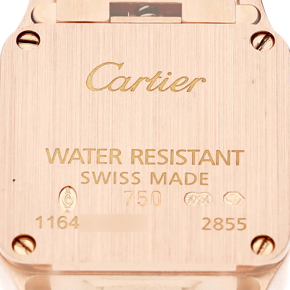 The image shows the case back of a Cartier Santos WF9011Z8 Women's Rose Gold Silver Dial watch, featuring engravings with brand and specifications.