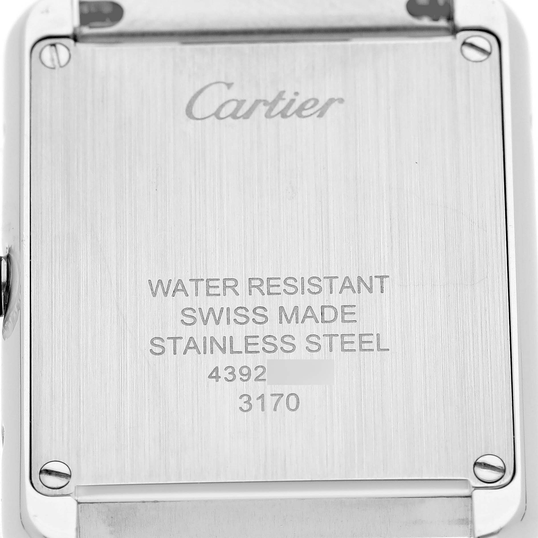The image shows the back of the Cartier Tank Solo W5200013 Women's Stainless Steel Silver Dial, highlighting engraving details and screws.
