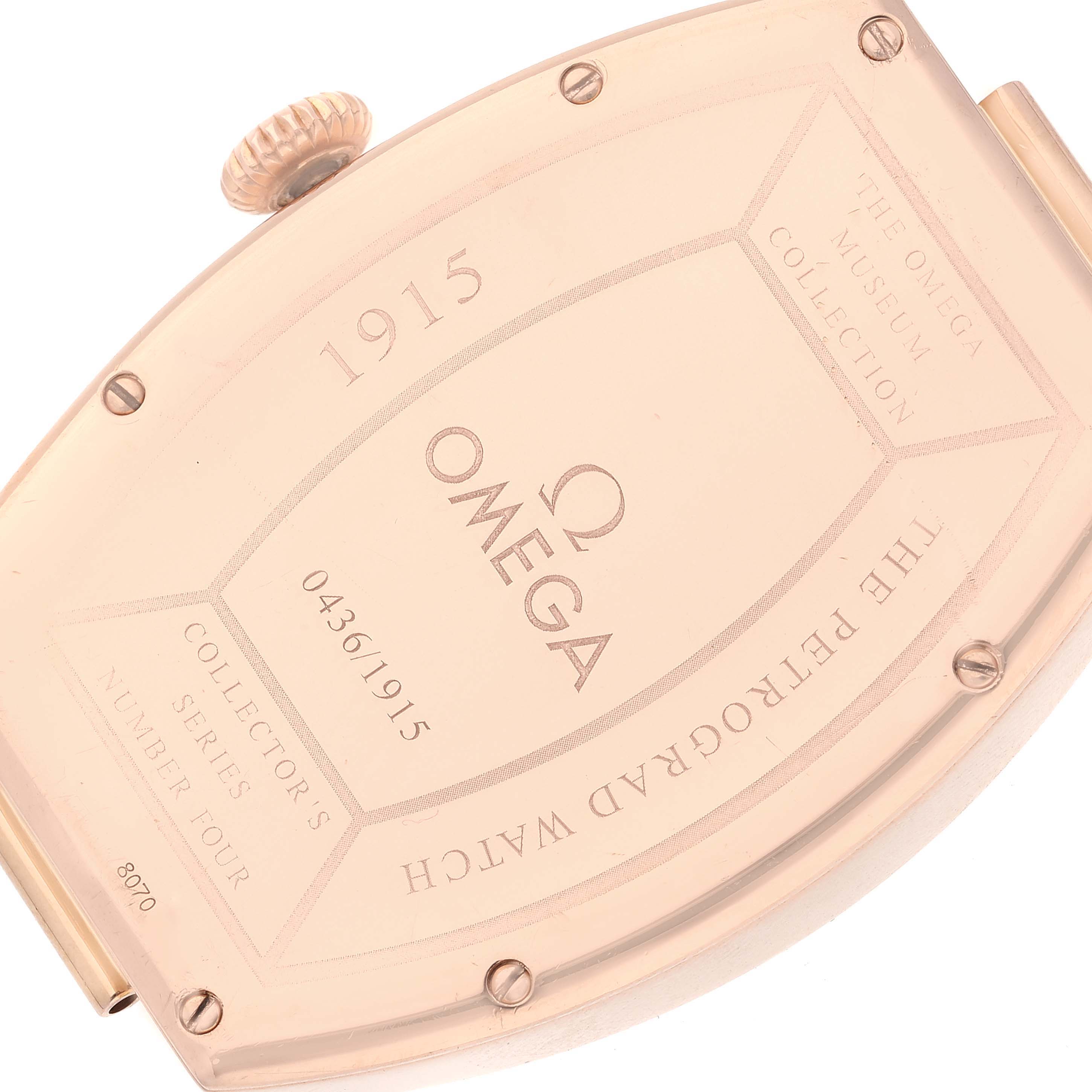 The image shows the back case and crown of the Omega Museum 5703.30.01 Men's Rose Gold Beige Dial 5703.30.01 Men's Rose Gold Beige Dial model 1915 watch from an angled top view.