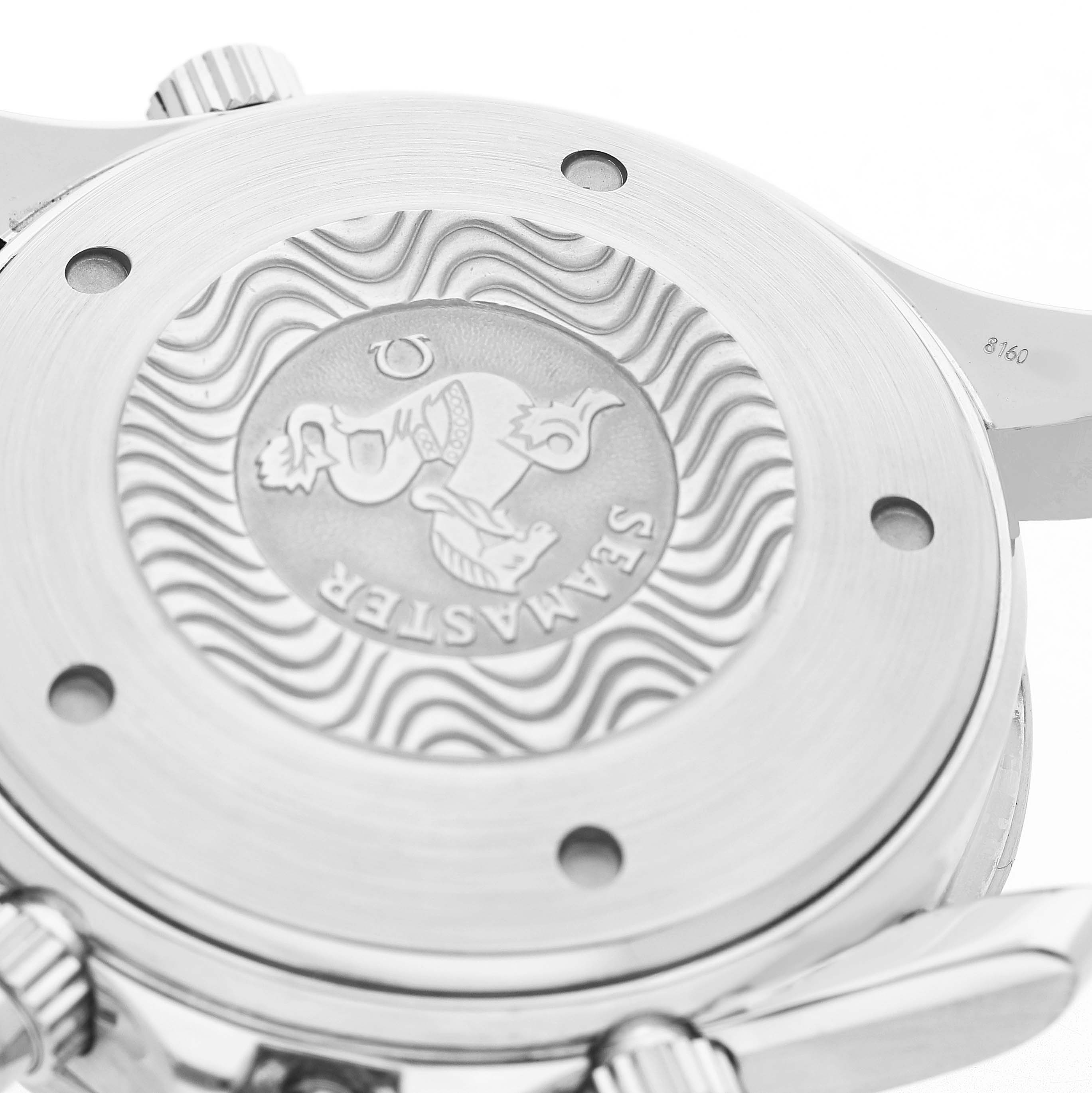 The image shows the back casing of an Omega Seamaster 2599.80.00 Men's Stainless Steel Blue Dial watch, highlighting its engraved emblem and brushed metal finish.