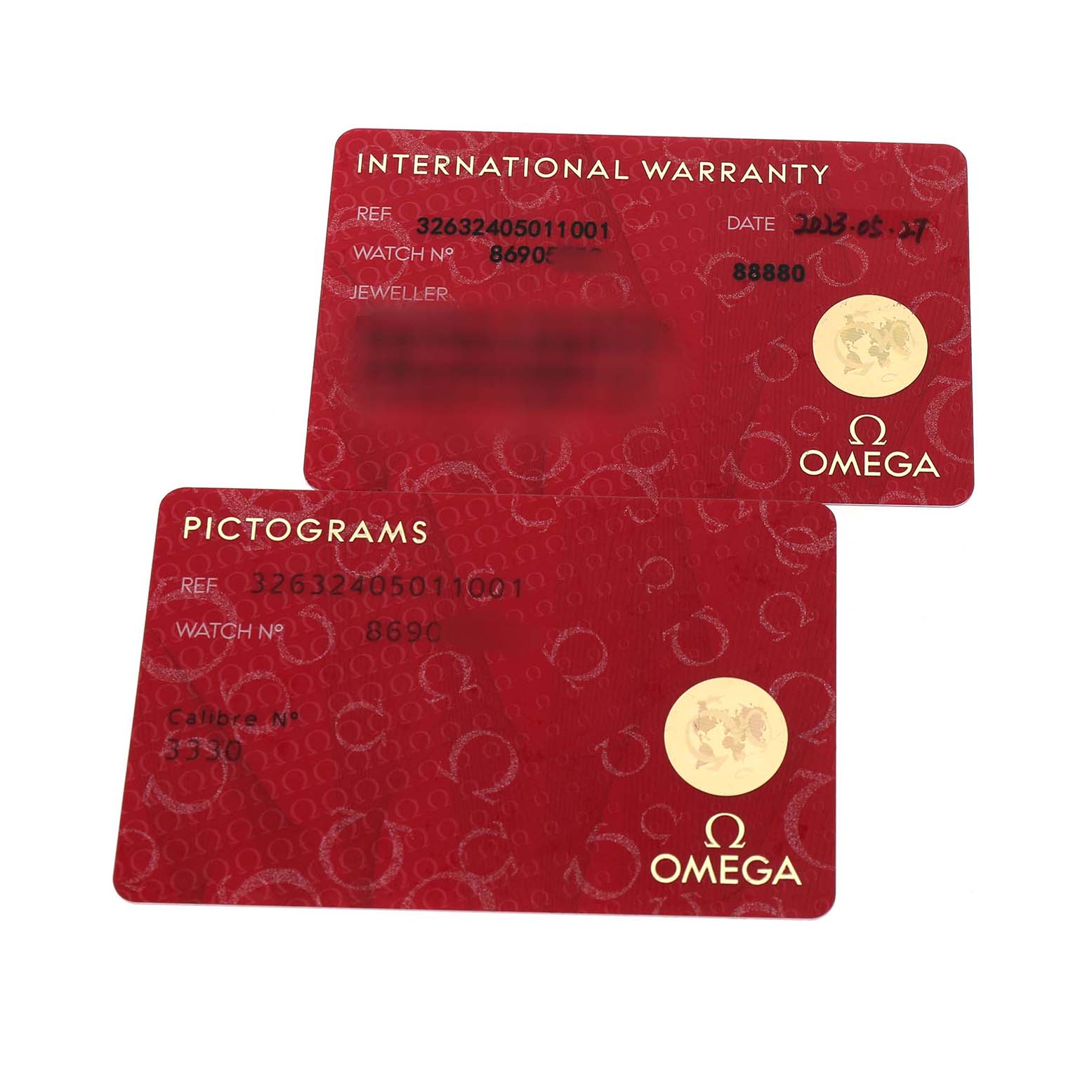 The image shows Omega Speedmaster 326.32.40.50.11.001 Men's Stainless Steel Red Dial's international warranty and pictograms cards at an angled view.