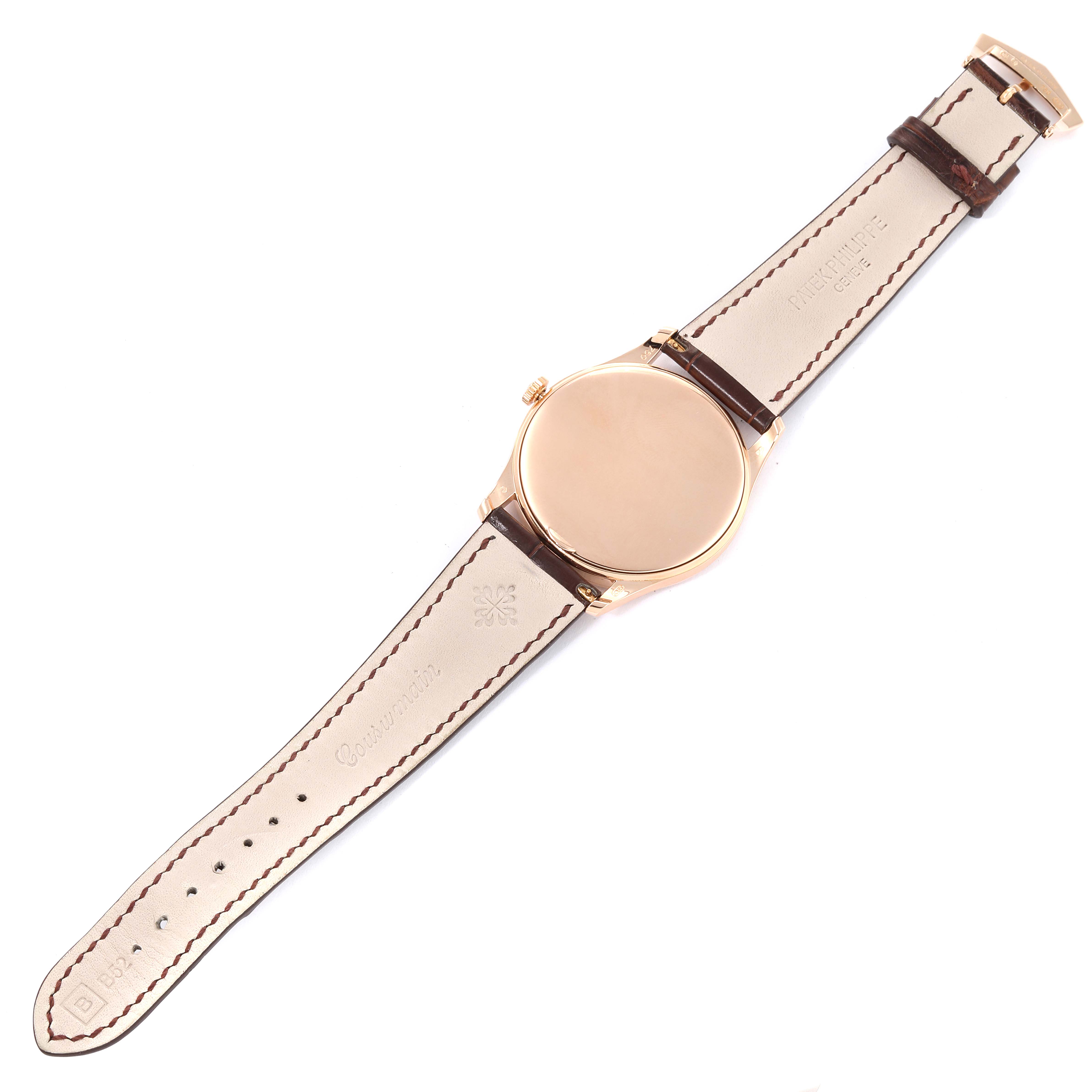 The image shows the back view of a Patek Philippe Calatrava 5196R Men
s Rose Gold Silver Dial 5196R Men
s Rose Gold Silver Dial watch, displaying its caseback and leather strap.