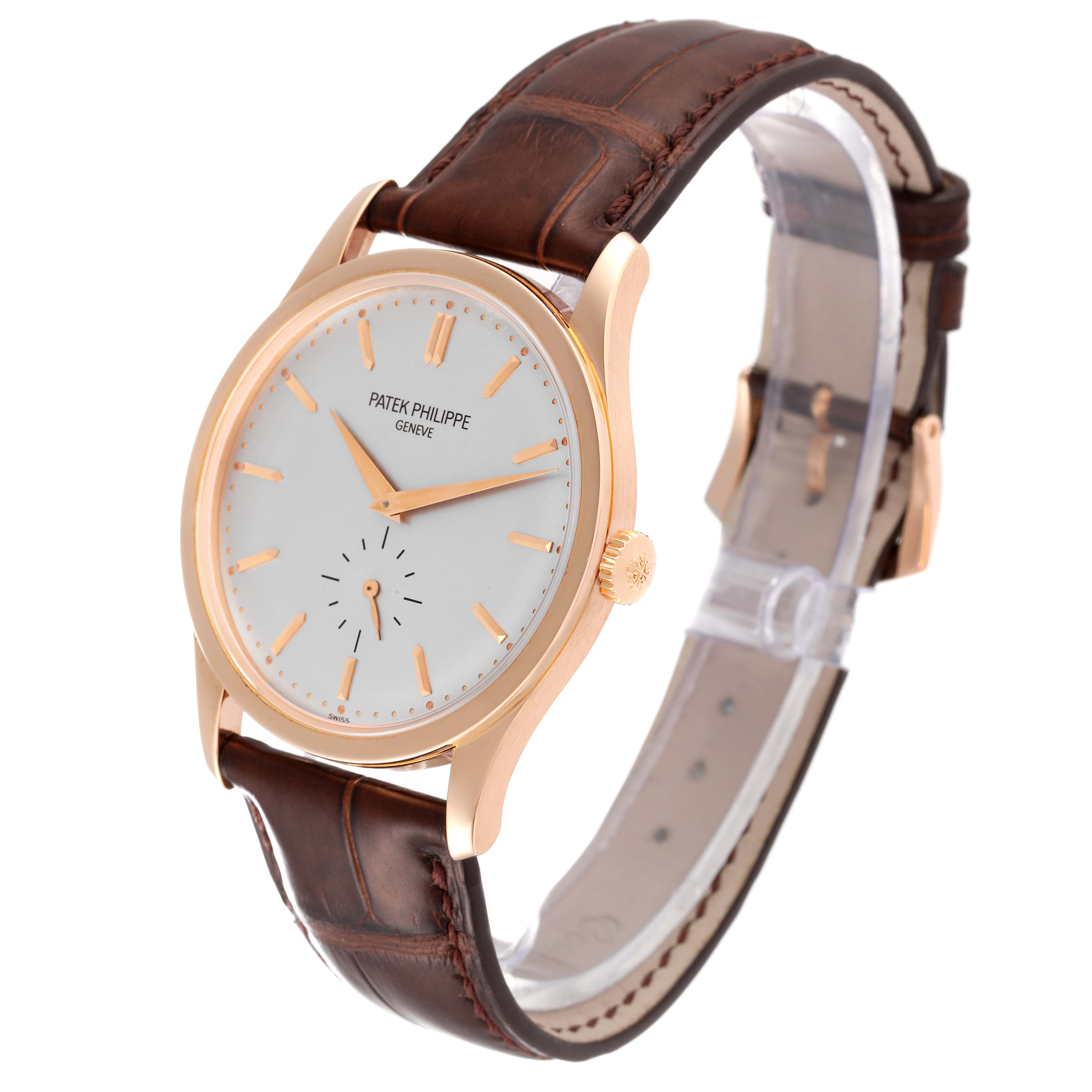 The image shows a Patek Philippe Calatrava 5196R Men
s Rose Gold Silver Dial 5196R Men
s Rose Gold Silver Dial watch at an angled side view, highlighting its brown leather strap and gold case.