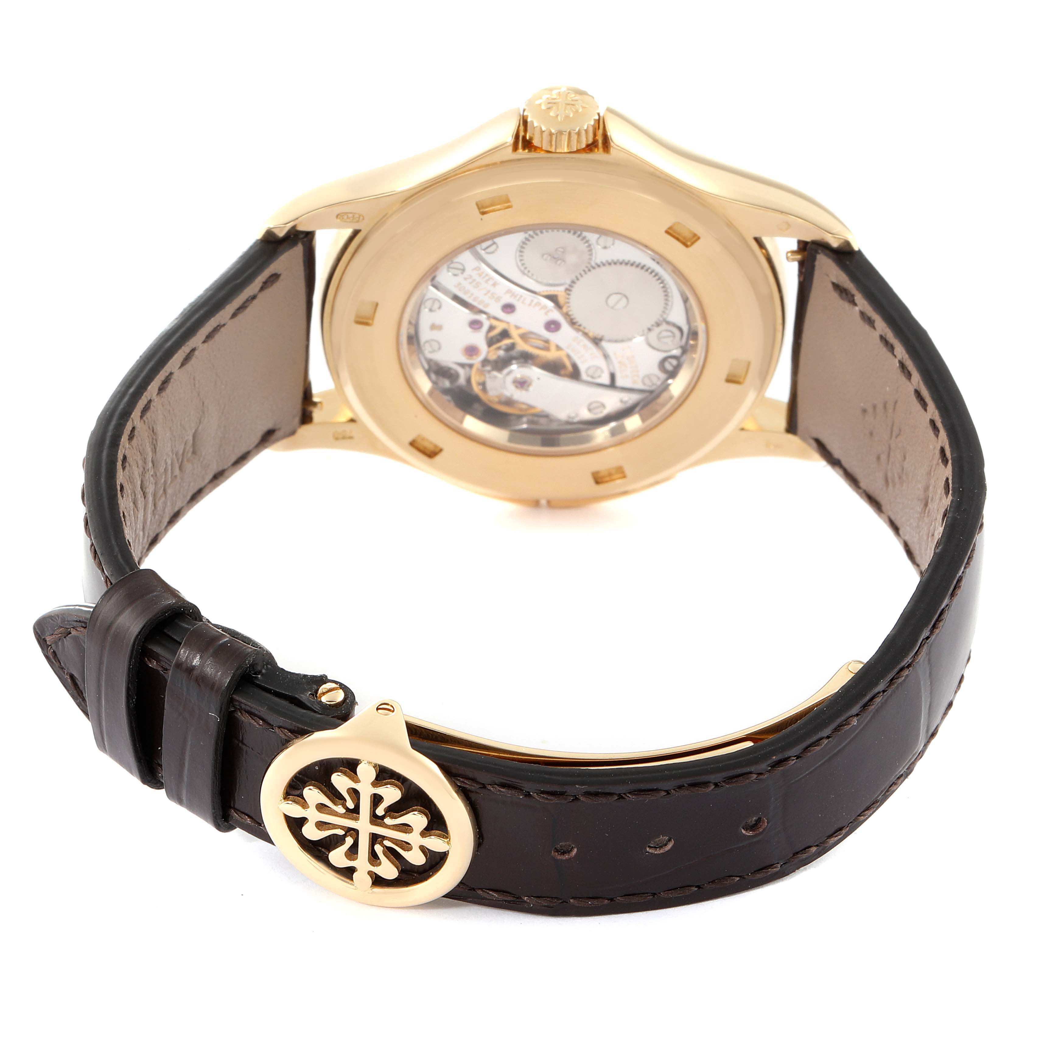 The image shows the back of the Patek Philippe Calatrava 5134J Men's Yellow Gold White Dial 5134J Men's Yellow Gold White Dial watch, highlighting its movement and leather strap.