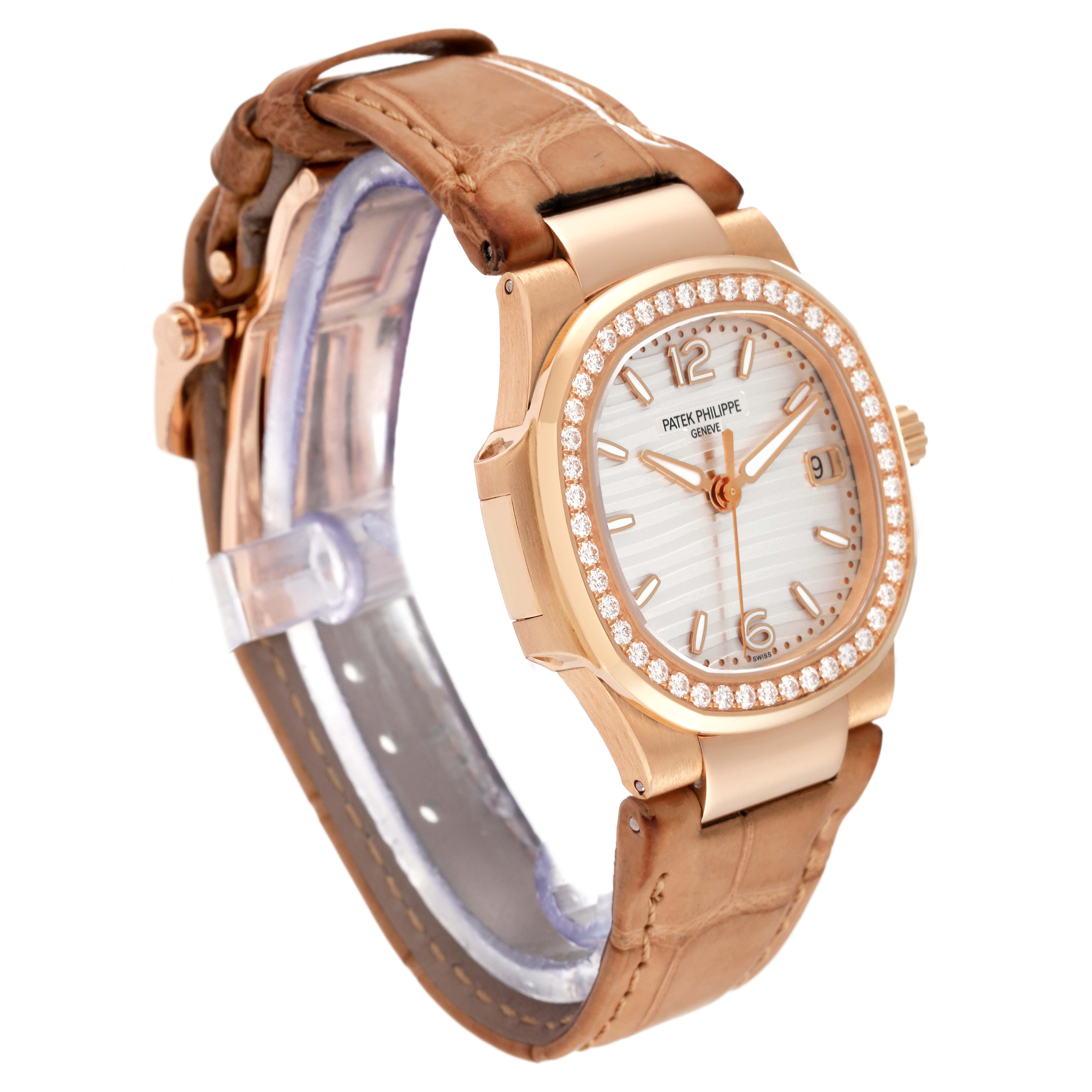 This is a side angle view of the Patek Philippe Nautilus 7010R Women's Rose Gold Silver Dial 7010R Women's Rose Gold Silver Dial watch, showing the face, strap, and clasp.