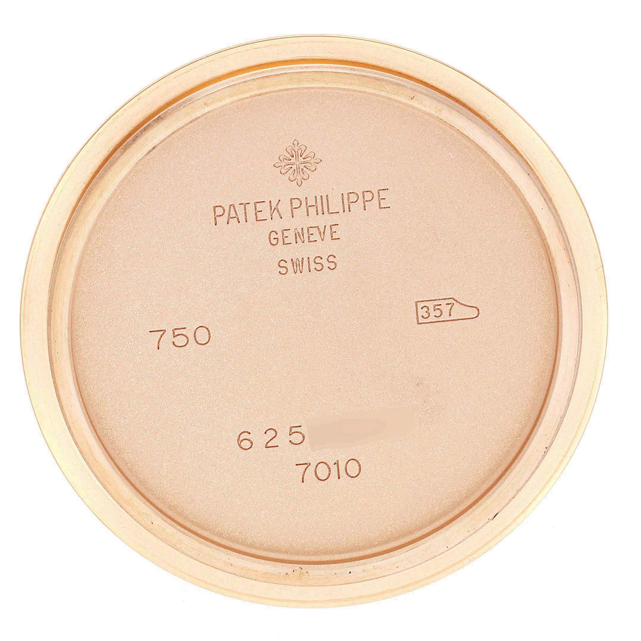 This is a close-up shot of the case back from a Patek Philippe Nautilus 7010R Women's Rose Gold Silver Dial 7010R Women's Rose Gold Silver Dial watch, showing engravings and markings.