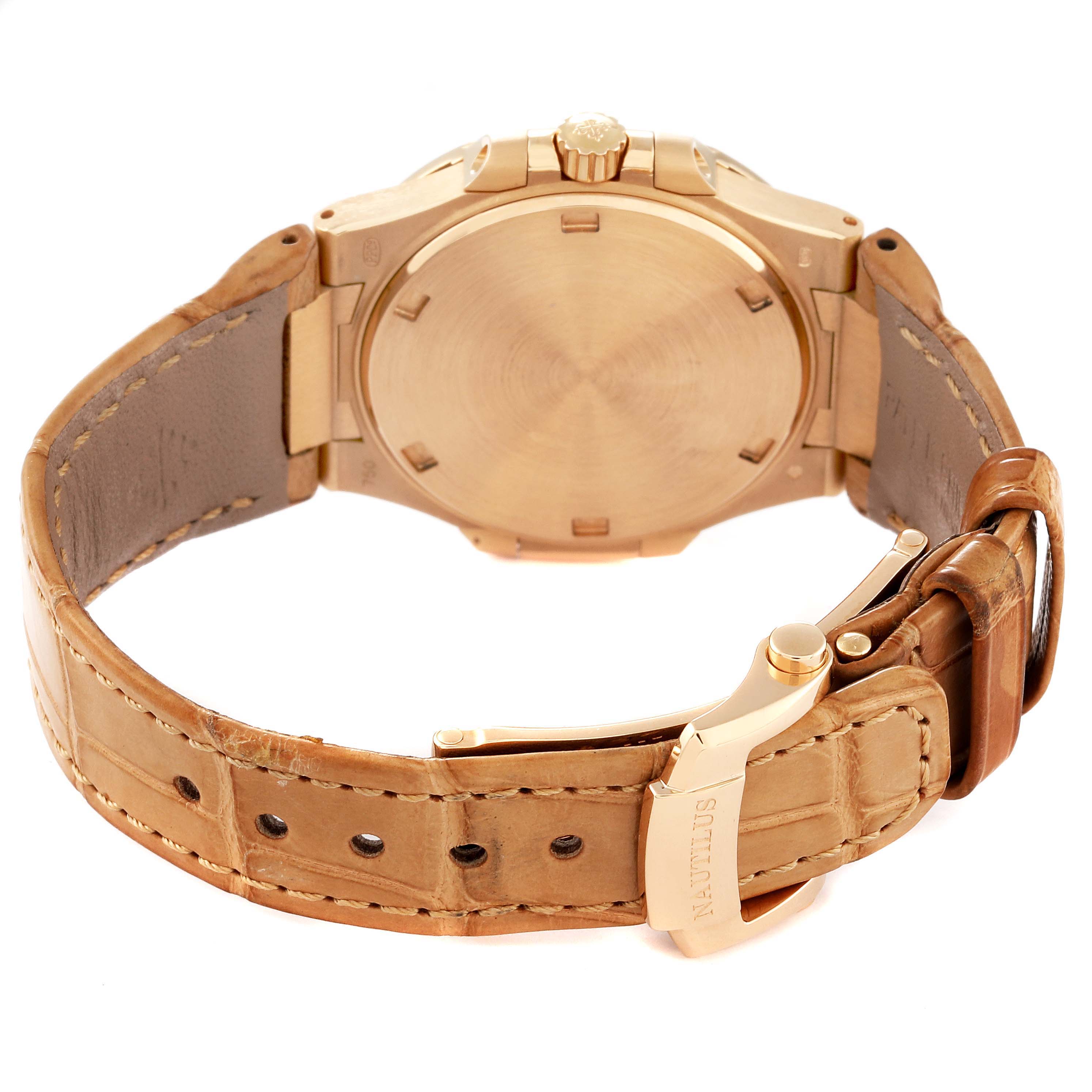 This image shows the rear view of a Patek Philippe Nautilus 7010R Women's Rose Gold Silver Dial 7010R Women's Rose Gold Silver Dial watch, featuring its case back, crown, and leather strap with clasp.