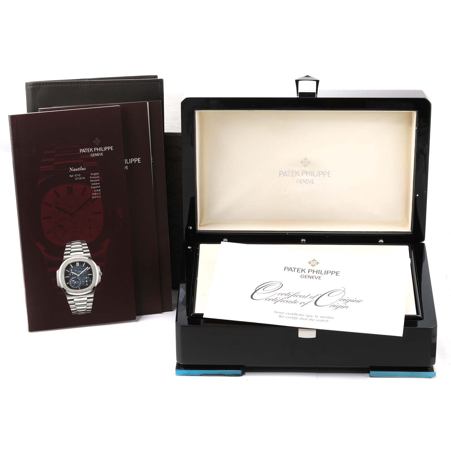 The image shows the Patek Philippe Nautilus 5712G-001 Men's White Gold Grey Dial 5712G-001 Men's White Gold Grey Dial watch with its open box, certificate, and manuals.