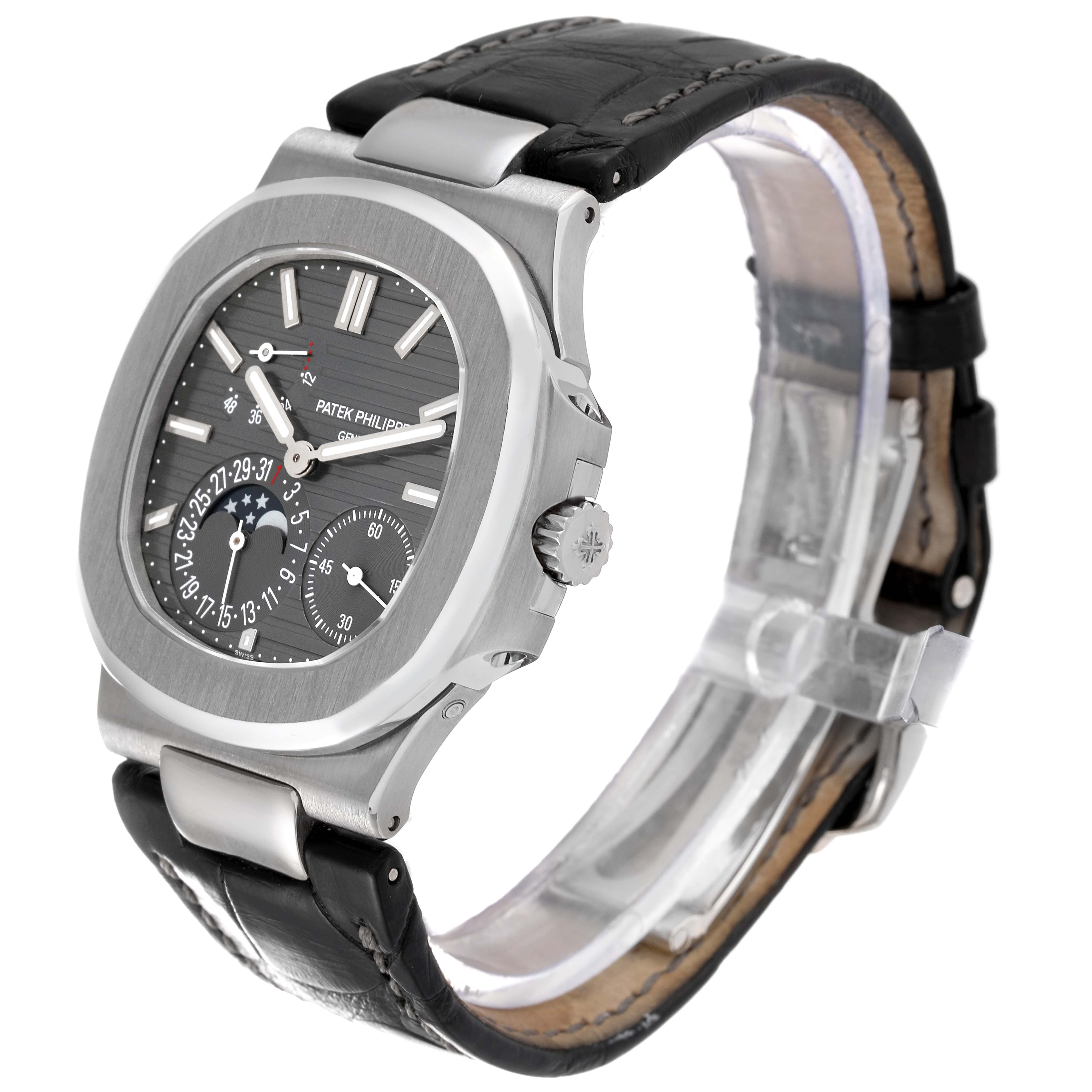 The image shows a Patek Philippe Nautilus 5712G-001 Men's White Gold Grey Dial 5712G-001 Men's White Gold Grey Dial watch at a three-quarter angle, depicting its face, case, and leather strap.