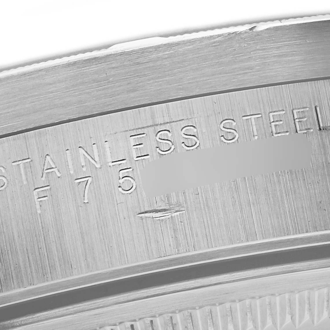 This close-up image shows the engraved text on the stainless steel case of a Rolex Air-King 14010 Men's Stainless Steel Black Dial 14010 Men's Stainless Steel Black Dial watch.