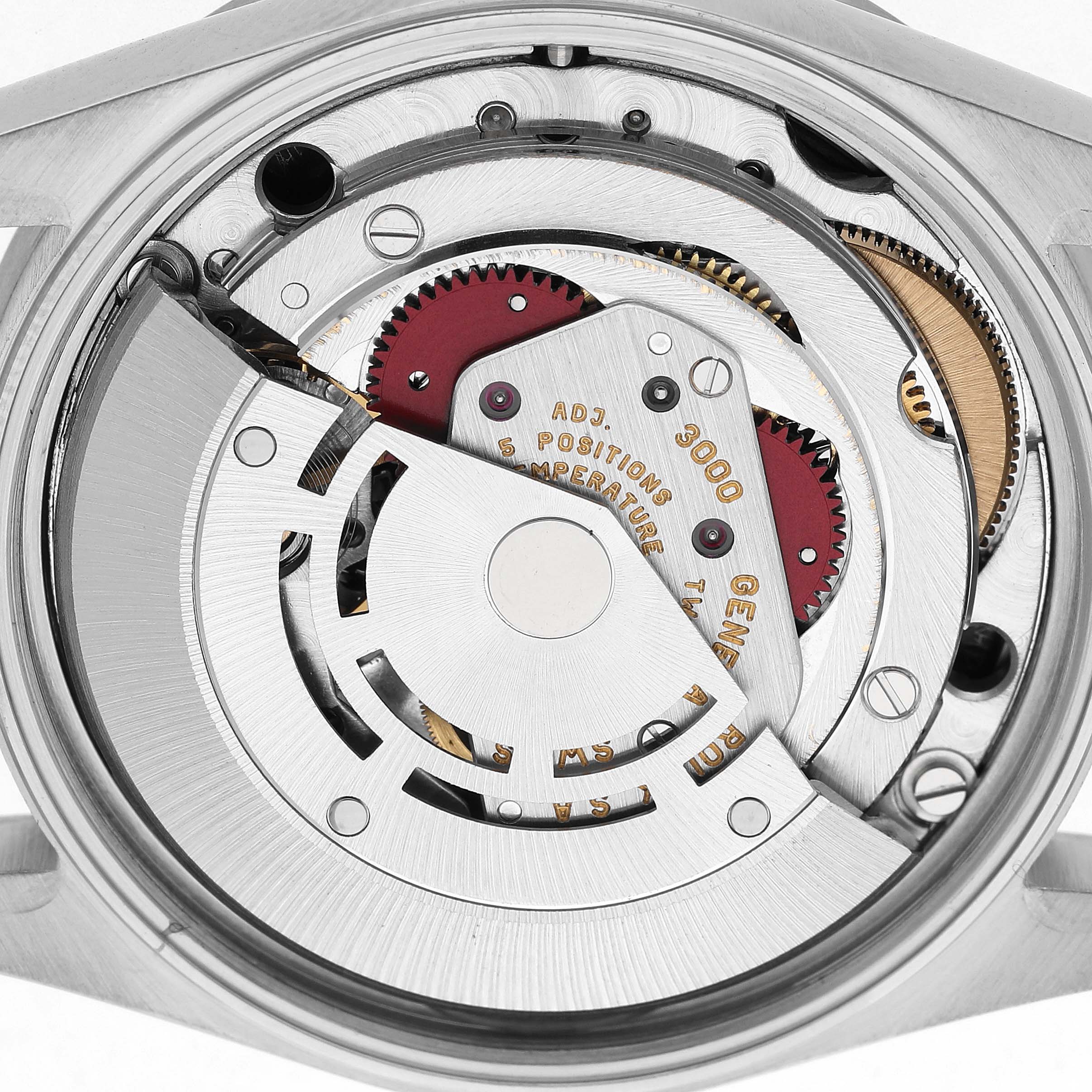 The image shows the movement of a Rolex Air-King 14010 Men's Stainless Steel Black Dial watch, focusing on the gears and mechanics inside the case back.