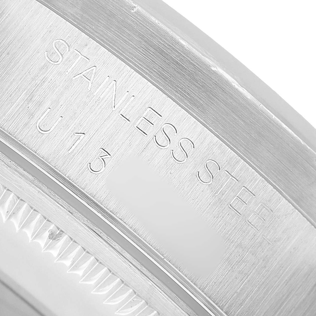 The image shows a close-up of the stainless steel bracelet clasp of a Rolex Air-King 14010 Men's Stainless Steel Black Dial watch, featuring engraved text.