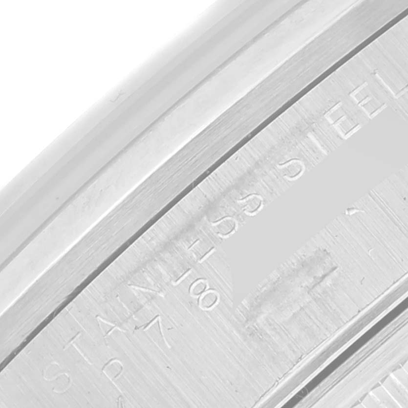 The image shows a close-up of the case back edge with "STAINLESS STEEL" engraving on a Rolex Date 15200 Men's Stainless Steel Blue Dial 15200 Men's Stainless Steel Blue Dial watch.