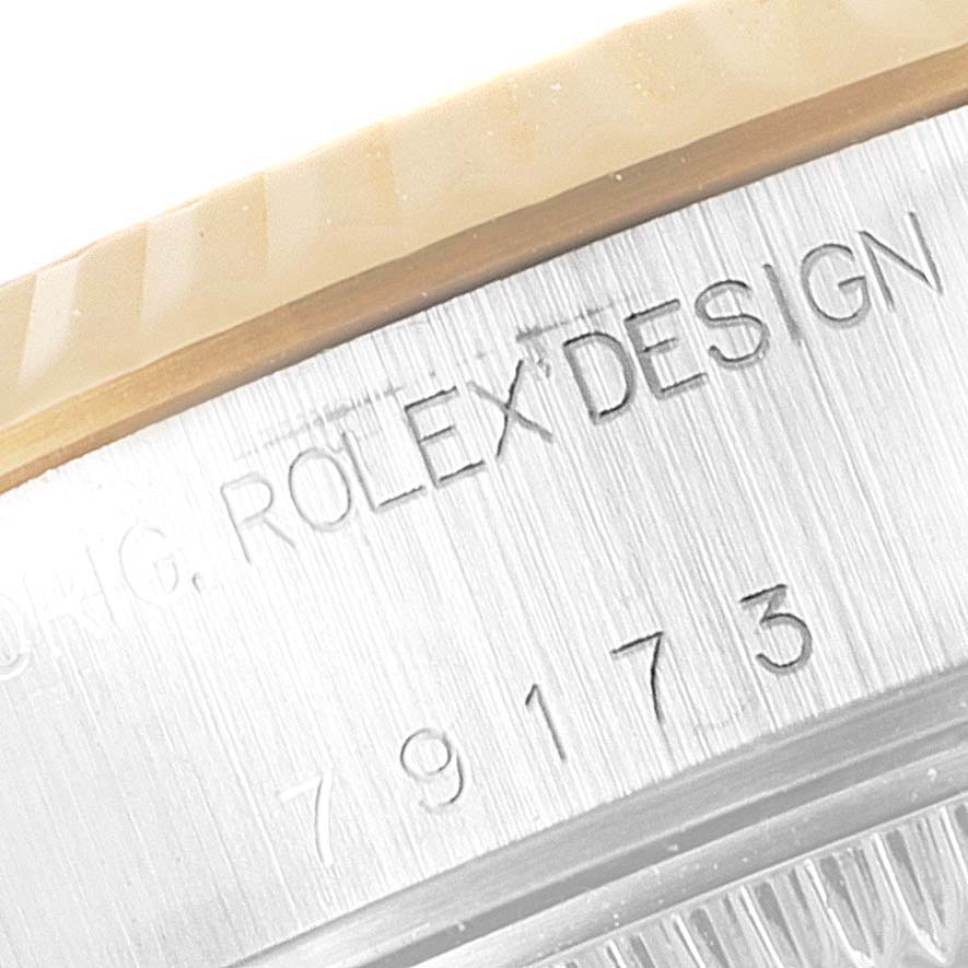 This image shows a close-up of the bezel and engraved text on the side of a Rolex Datejust 79173 Women
s Steel and Gold (two tone) White Dial 79173 Women
s Steel and Gold (two tone) White Dial watch.