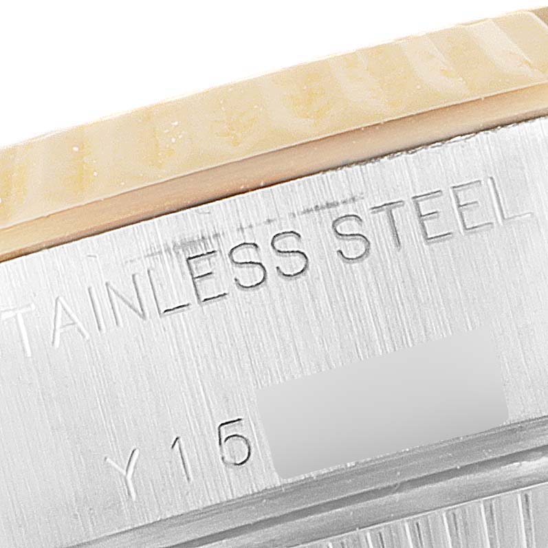 This image shows a close-up angle of the side of the case back for a Rolex Datejust 79173 Women
s Steel and Gold (two tone) White Dial 79173 Women
s Steel and Gold (two tone) White Dial model, displaying the "STAINLESS STEEL" engraving.