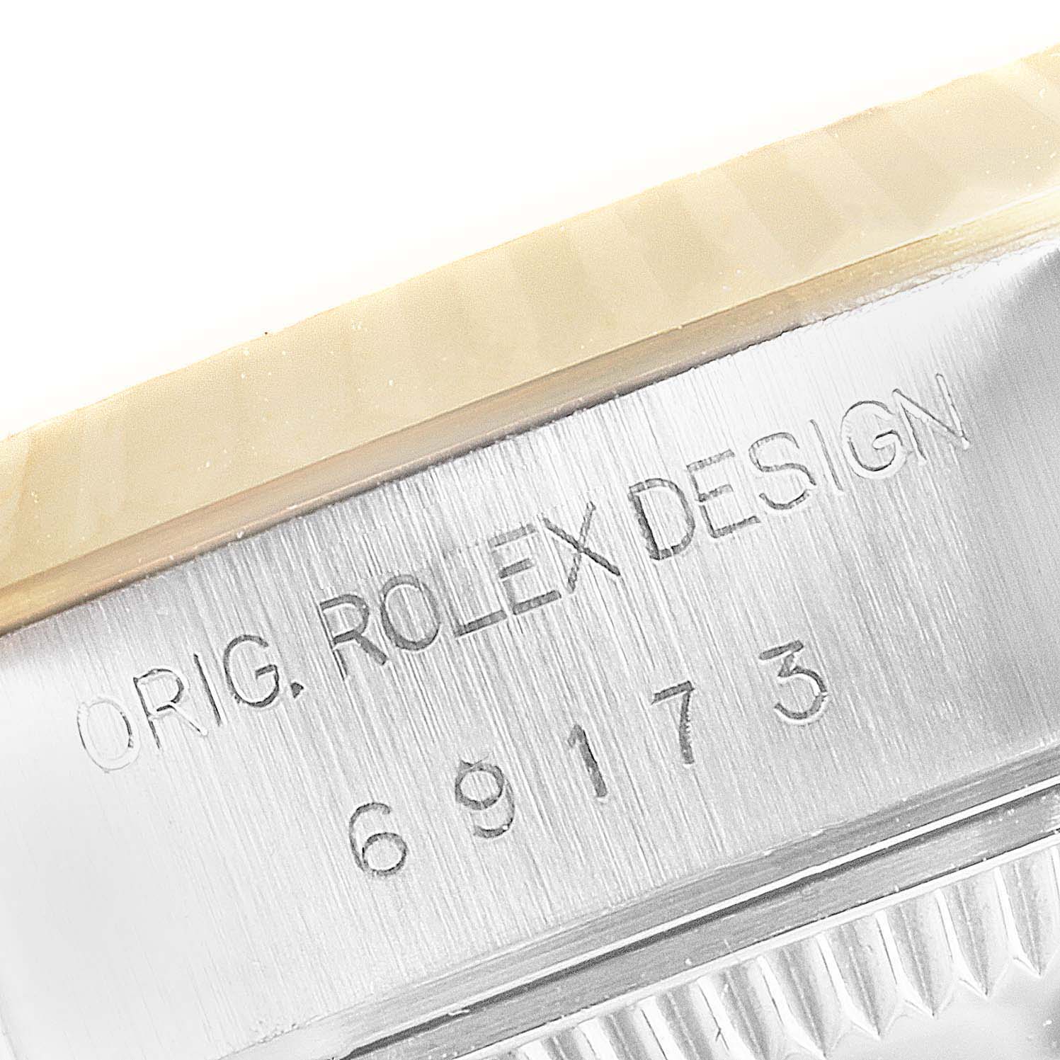 This image shows a close-up of the side case of a Rolex Datejust 69173 Women
s Steel and Gold (two tone) Champagne Dial 69173 Women
s Steel and Gold (two tone) Champagne Dial model, revealing the engraved model number "69173."
