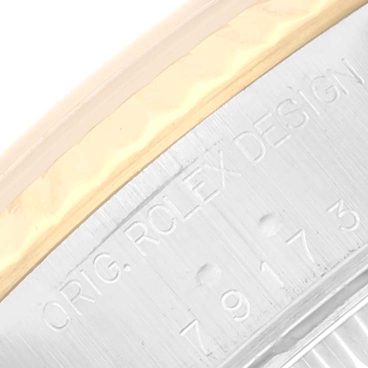 This is a close-up angle showing the engraved bezel of a Rolex Datejust 79173 Women's Steel and Gold (two tone) Champagne Dial 79173 Women's Steel and Gold (two tone) Champagne Dial watch.