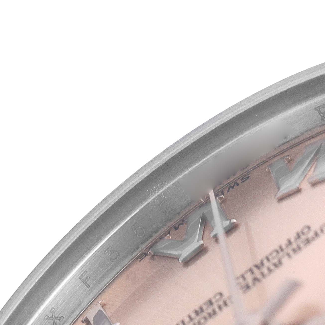 The image shows a close-up of the bezel and part of the dial of a Rolex Datejust 178240 Women's Stainless Steel Pink Dial, focusing on the Roman numeral markers.