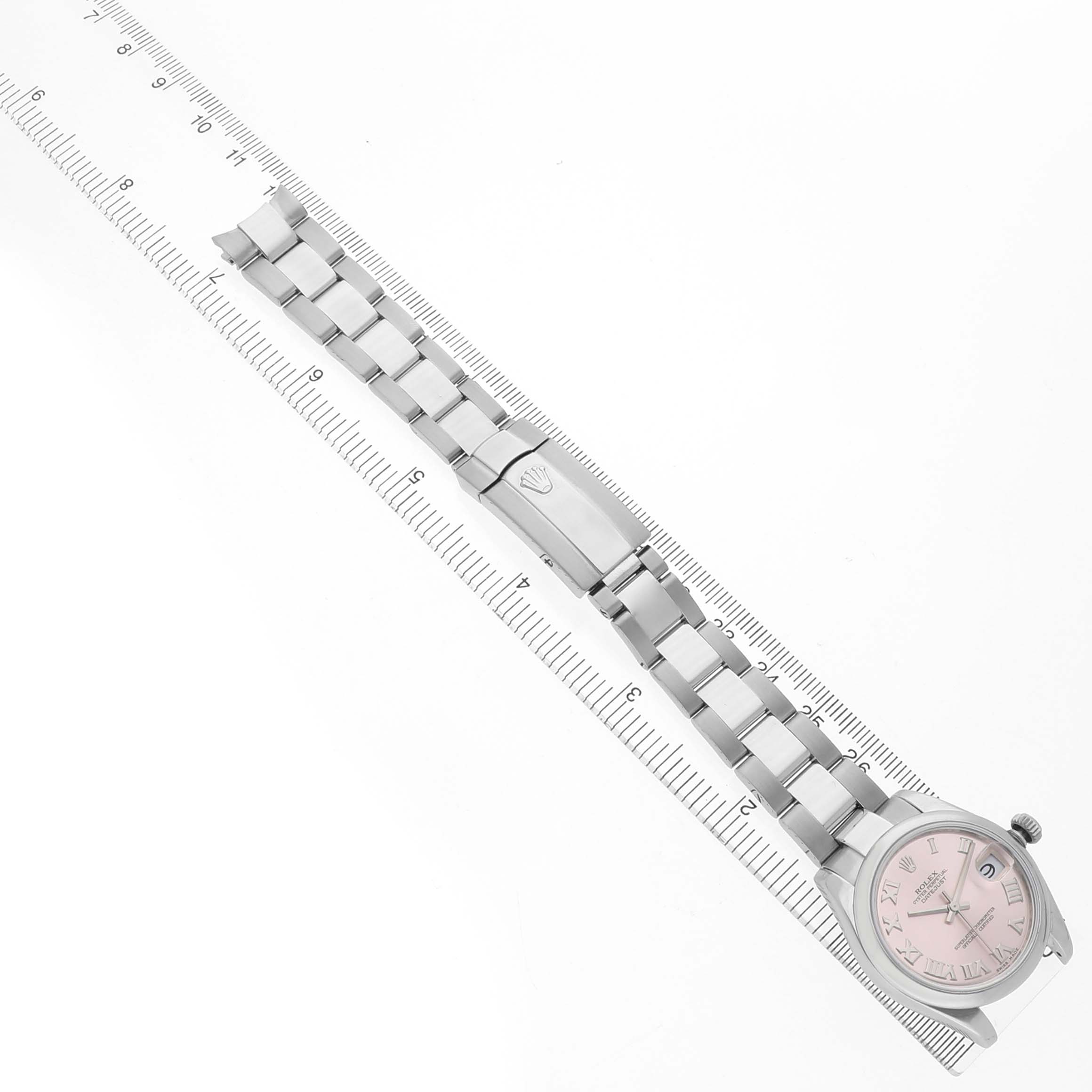 The image shows a Rolex Datejust 178240 Women's Stainless Steel Pink Dial watch laid flat, displaying the bracelet, clasp, and face at an oblique angle next to a ruler.
