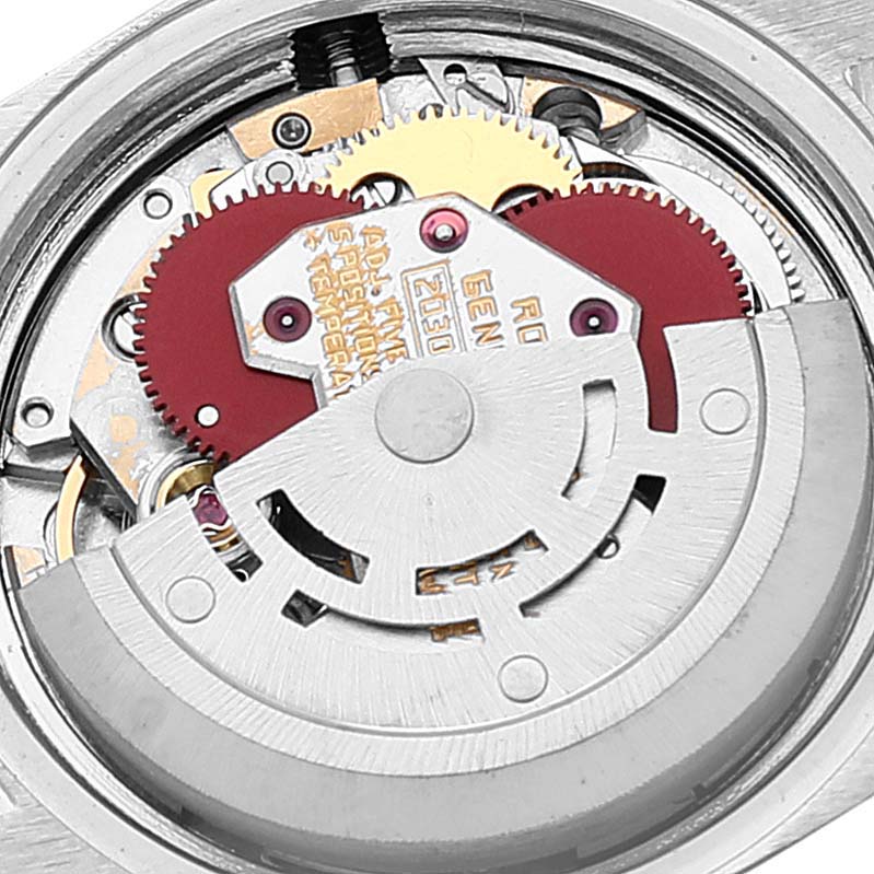 This image shows a close-up of the movement mechanism inside a Rolex Date 6917 Women's Stainless Steel Silver Dial 6917 Women's Stainless Steel Silver Dial model watch, highlighting gears and the rotor.