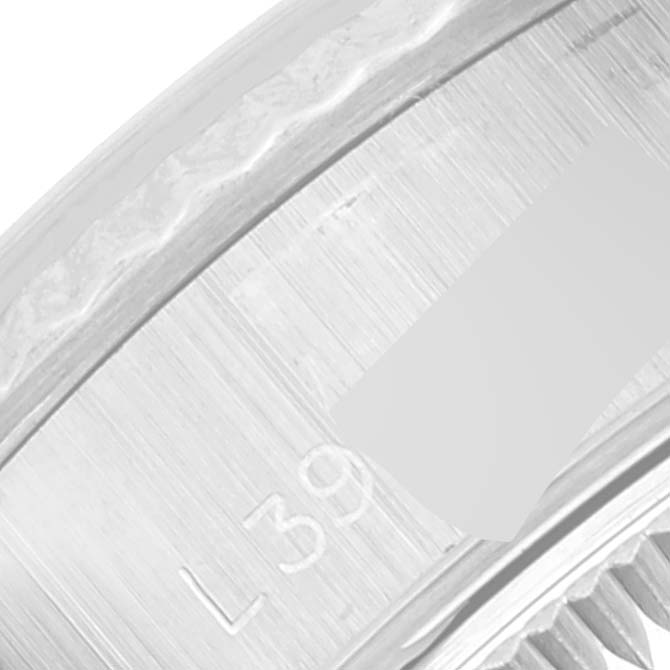 The image shows a close-up of the case side and part of the bezel of the Rolex Datejust 69174 Women's Stainless Steel Silver Dial 69174 Women's Stainless Steel Silver Dial watch, focusing on the serial number engraving.