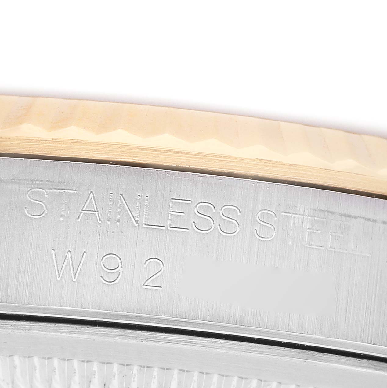 The image shows a close-up of the side of a Rolex Datejust 16233 Men's Stainless Steel Champagne Dial's case, highlighting the stainless steel and model engraving.