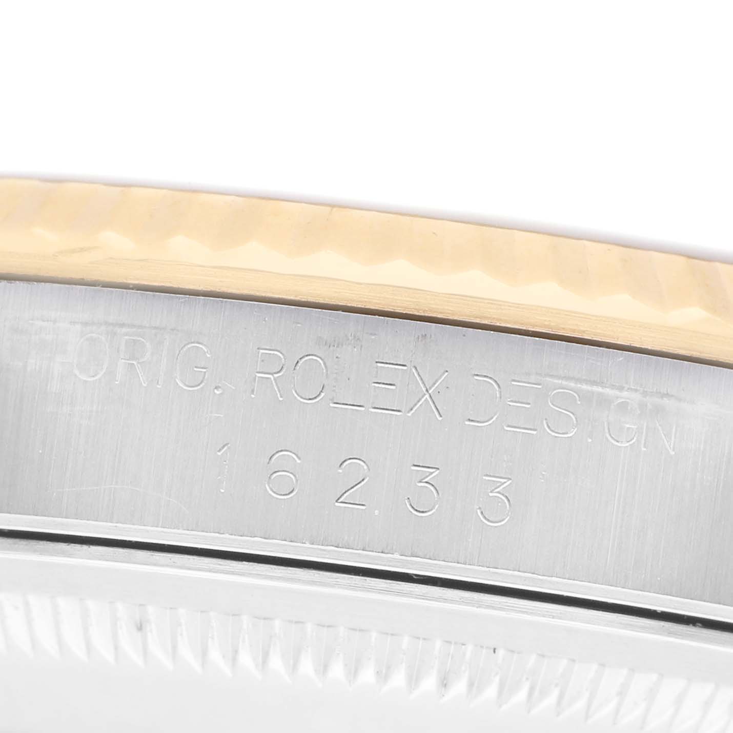 The image shows the side view of a Rolex Datejust 16233 Men's Stainless Steel Champagne Dial, highlighting the bezel and engraved serial numbers on the case.