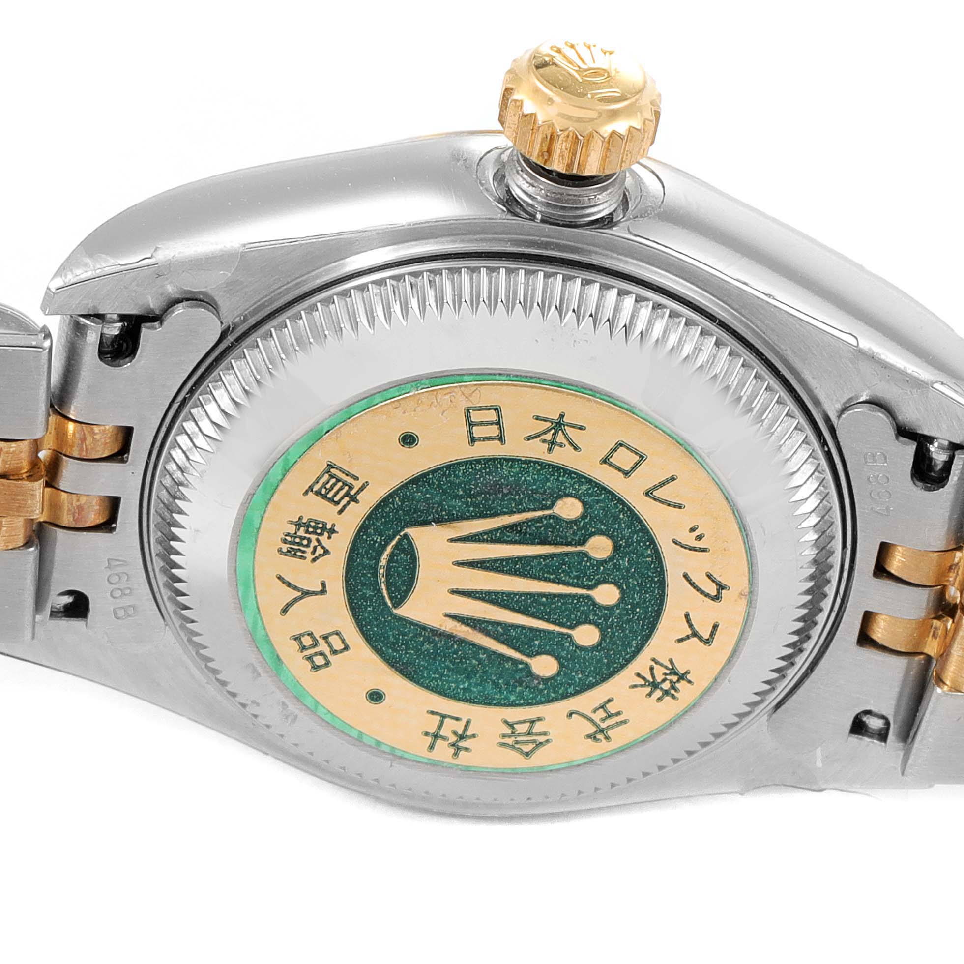 The image shows the holographic case back and crown of a Rolex Datejust 79173 Women
s Steel and Gold (two tone) Mother of Pearl Dial 79173 Women
s Steel and Gold (two tone) Mother of Pearl Dial watch.