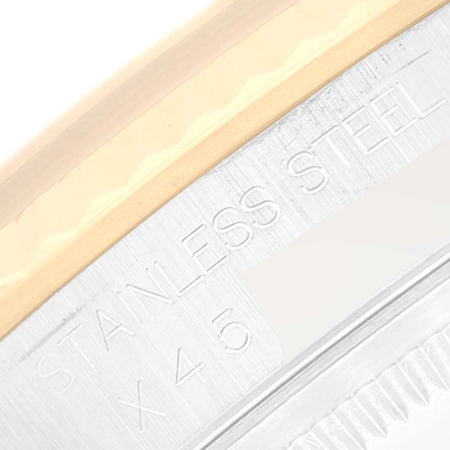 Close-up of the edge of a Rolex Datejust 16233 Men's Steel and Gold (two tone) Champagne Dial 16233 Men's Steel and Gold (two tone) Champagne Dial watch, showing the stainless steel detailing and part of the bezel.