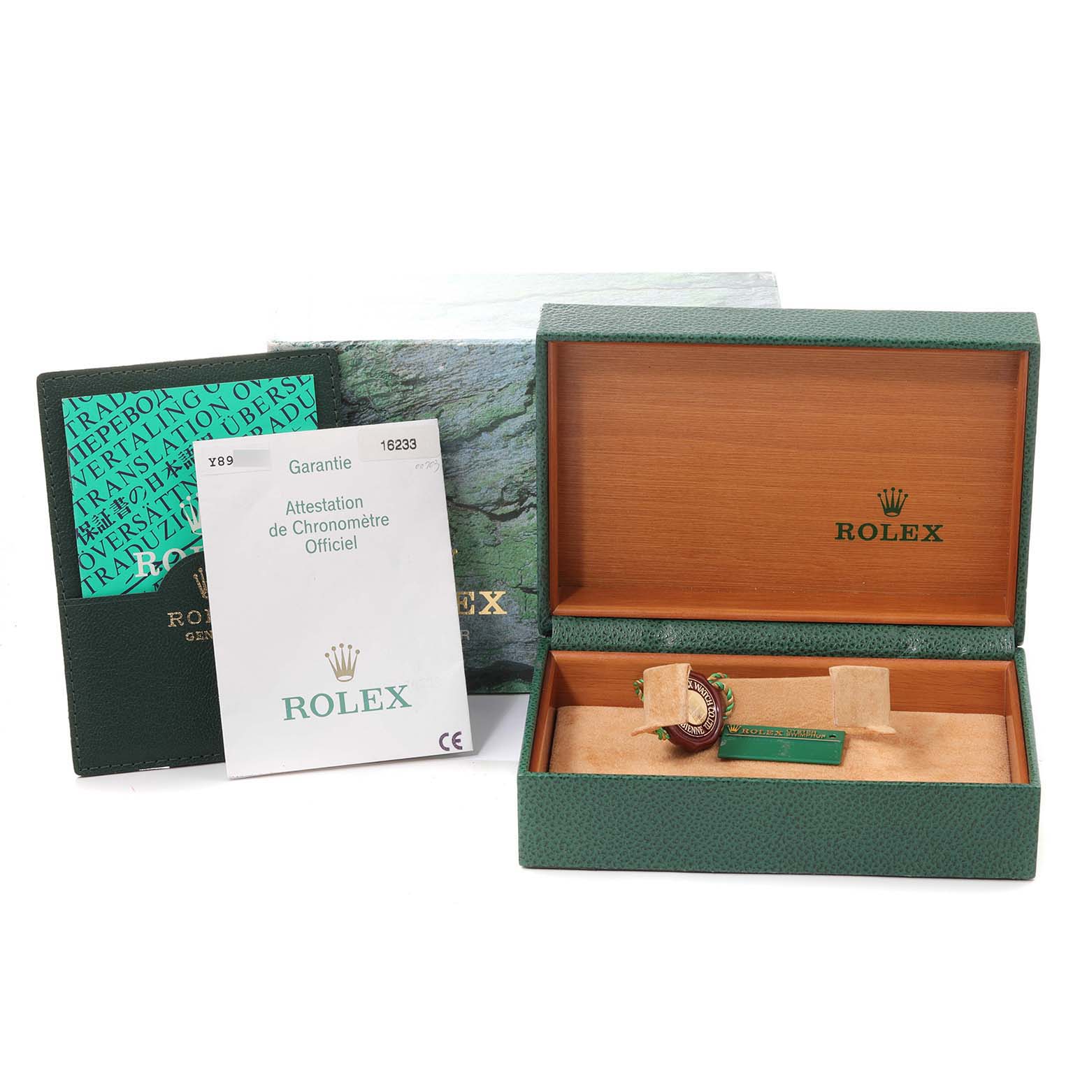 This image shows the packaging, warranty card, and accessories for a Rolex Datejust 16233 Men's Steel and Gold (two tone) Champagne Dial 16233 Men's Steel and Gold (two tone) Champagne Dial watch, including the green box with the Rolex logo.