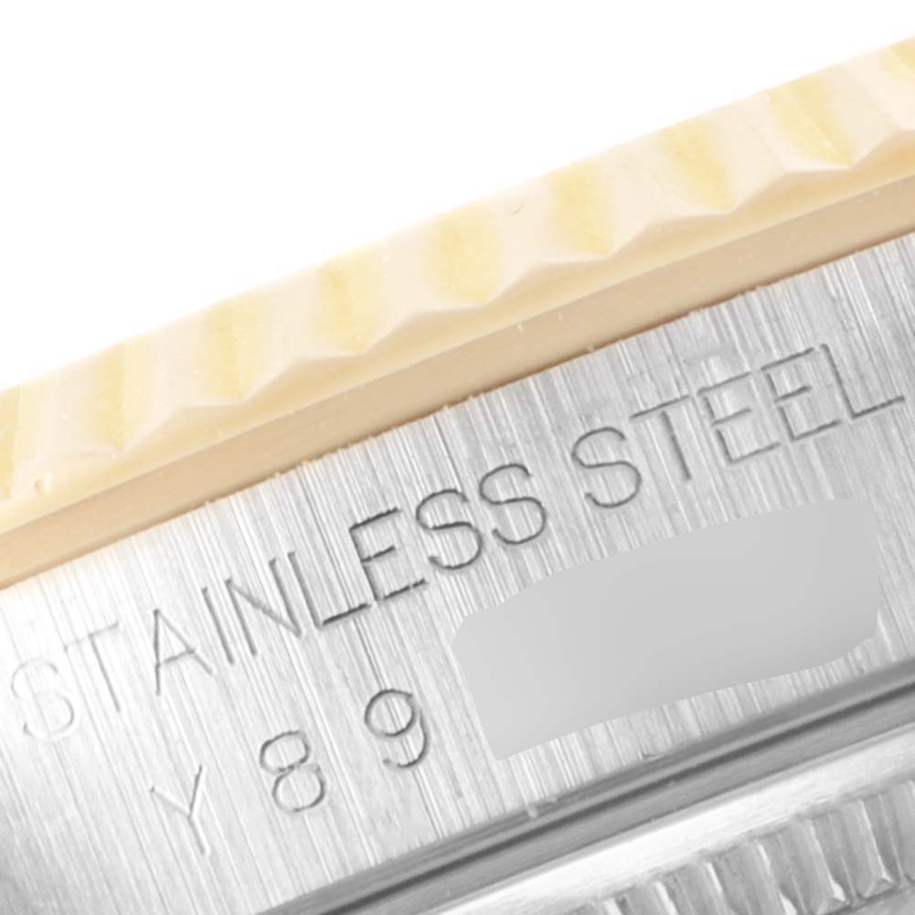 The image shows a close-up of the fluted bezel and part of the case band where "STAINLESS STEEL" is engraved on a Rolex Datejust 16233 Men's Steel and Gold (two tone) Champagne Dial 16233 Men's Steel and Gold (two tone) Champagne Dial watch.