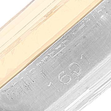 This close-up view of a Rolex Vintage Collection 1601 Men's Steel and Gold (two tone) Silver Dial 1601 Men's Steel and Gold (two tone) Silver Dial watch displays the model number engraved on the side.