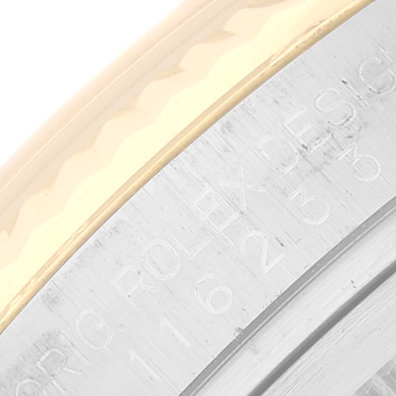 The image shows a close-up of the engraved bezel and case of a Rolex Datejust 116233 Men's Steel and Gold (two tone) Silver Dial 116233 Men's Steel and Gold (two tone) Silver Dial watch.