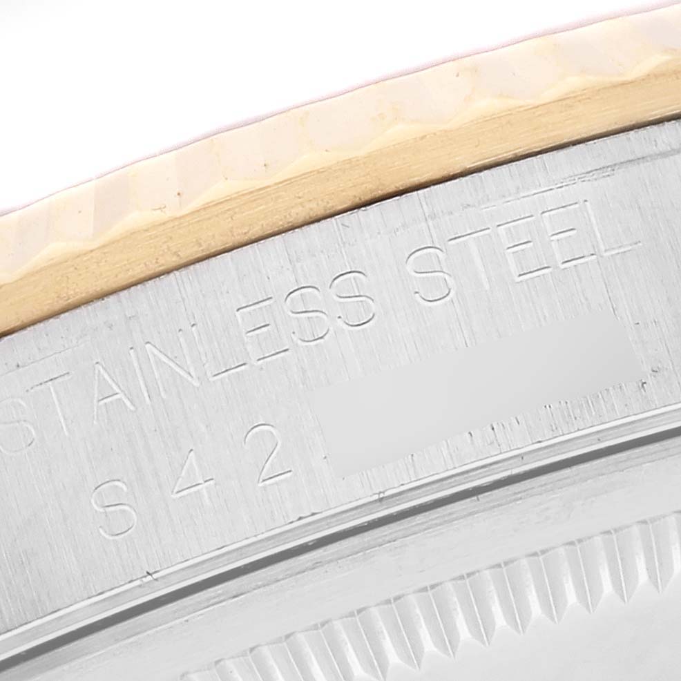 This image shows a close-up of the case back edge of a Rolex Datejust 16233 Men's Steel and Gold (two tone) Grey Dial 16233 Men's Steel and Gold (two tone) Grey Dial model, highlighting the "STAINLESS STEEL" engraving.