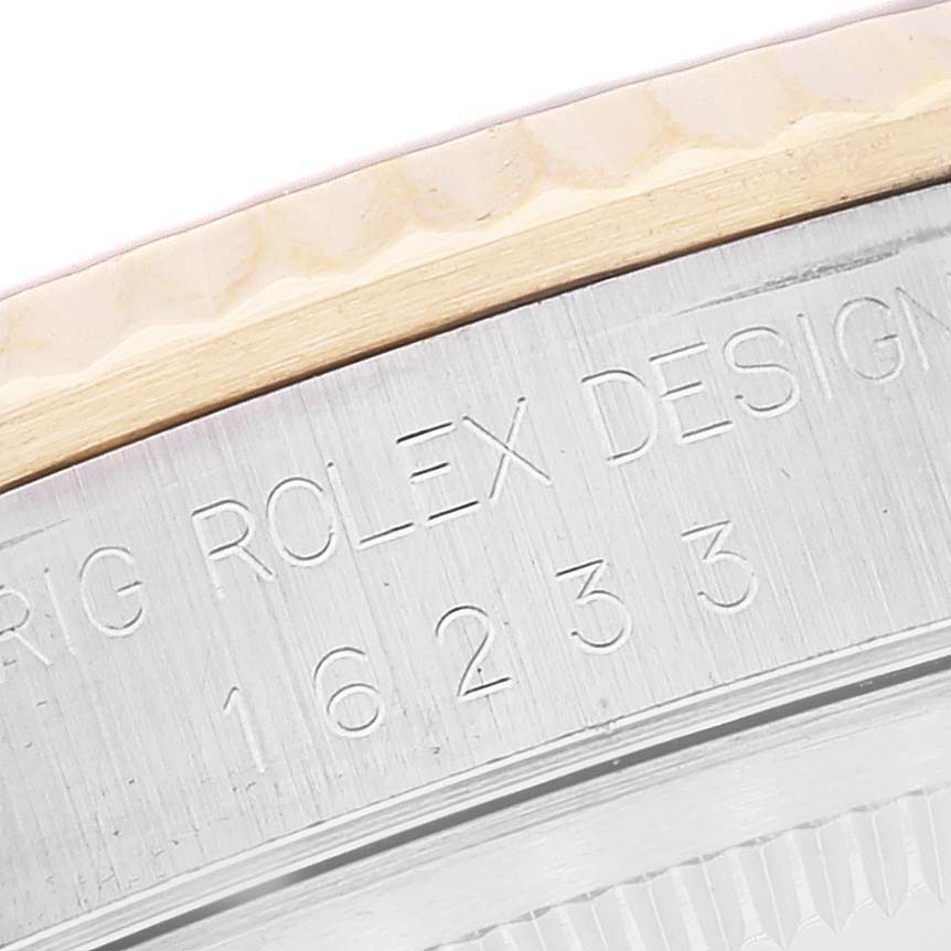 This image shows a close-up of the engraved bezel and case of a Rolex Datejust 16233 Men's Steel and Gold (two tone) Grey Dial 16233 Men's Steel and Gold (two tone) Grey Dial watch.