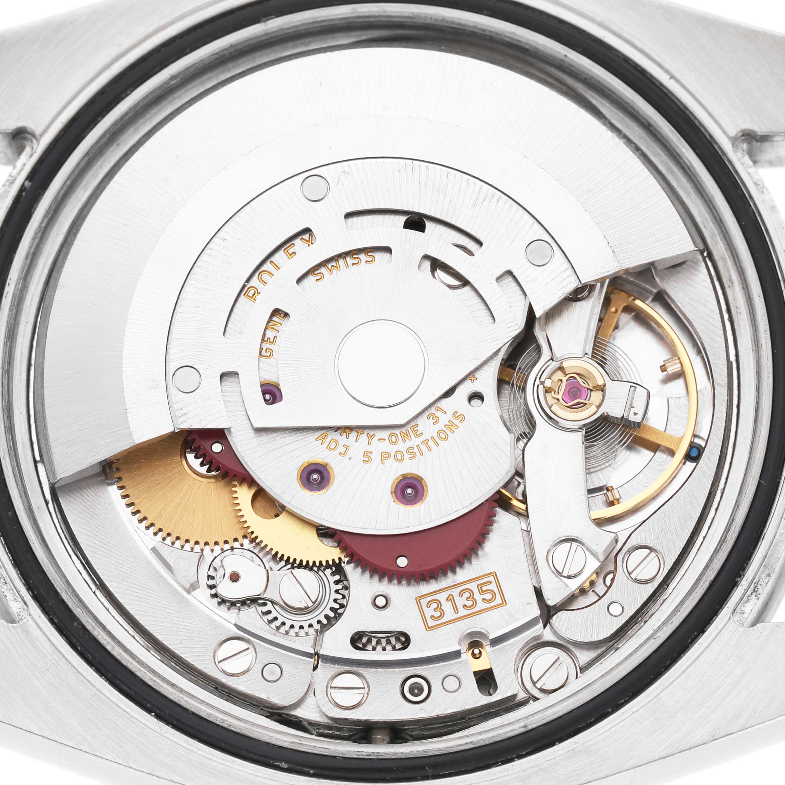 The image shows the intricate movement of the Rolex Turn-o-Graph 116264 Men's Stainless Steel Blue Dial watch from a top-down angle, highlighting its gears and components.