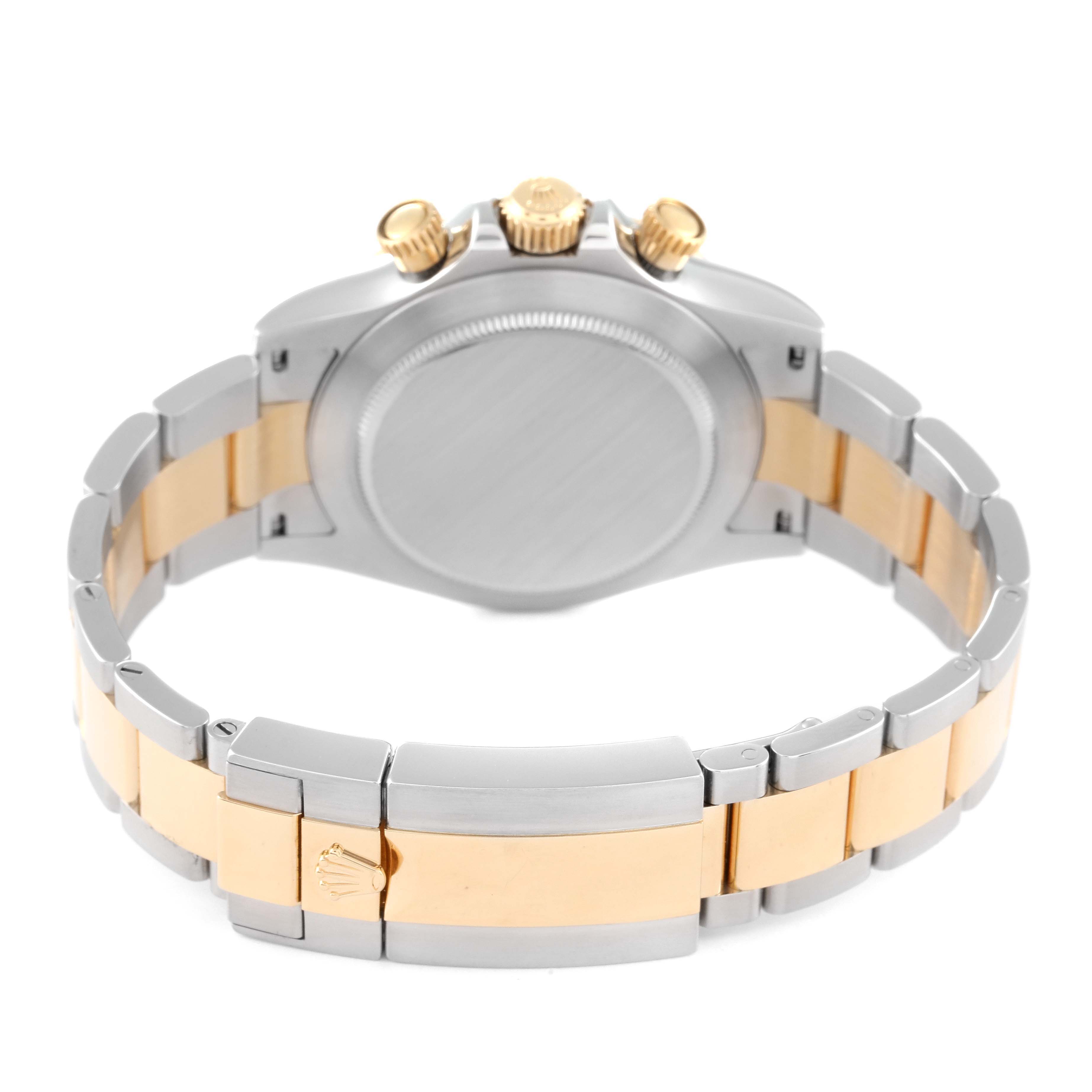 The image shows the back view of a Rolex Daytona 116503 Men's Steel and Gold (two tone) Mother of Pearl Dial 116503 Men's Steel and Gold (two tone) Mother of Pearl Dial watch, highlighting the case, crown, and two-tone bracelet.