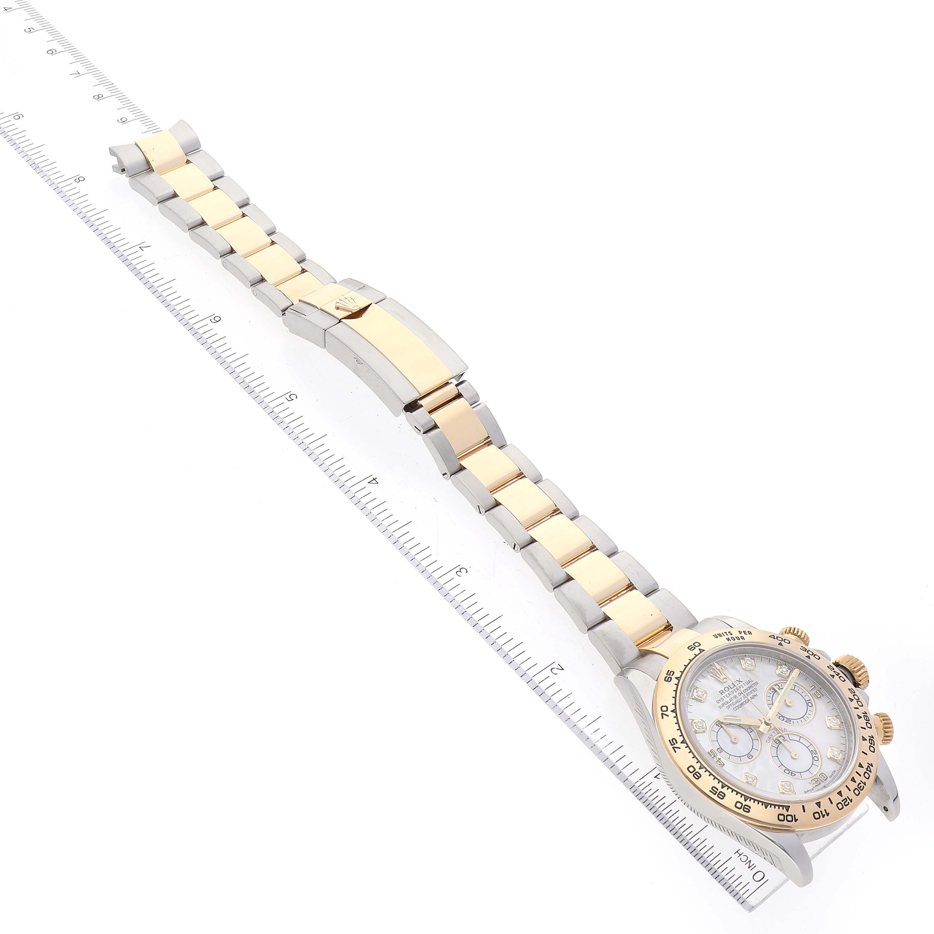 The image shows a Rolex Daytona 116503 Men's Steel and Gold (two tone) Mother of Pearl Dial 116503 Men's Steel and Gold (two tone) Mother of Pearl Dial watch laid flat, highlighting the watch face, bracelet, and clasp, measured against a ruler.
