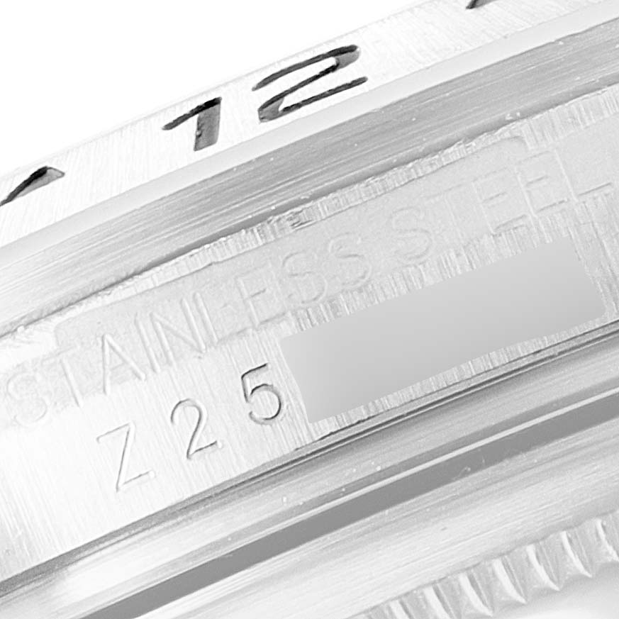 This close-up image of the Rolex Explorer 16570 Men's Stainless Steel White Dial 16570 Men's Stainless Steel White Dial watch shows part of its stainless steel case with engraved markings.
