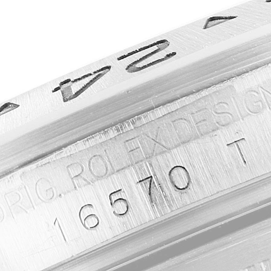 This image shows a close-up of the engraved bezel and case of a Rolex Explorer 16570 Men's Stainless Steel White Dial 16570 Men's Stainless Steel White Dial model watch.