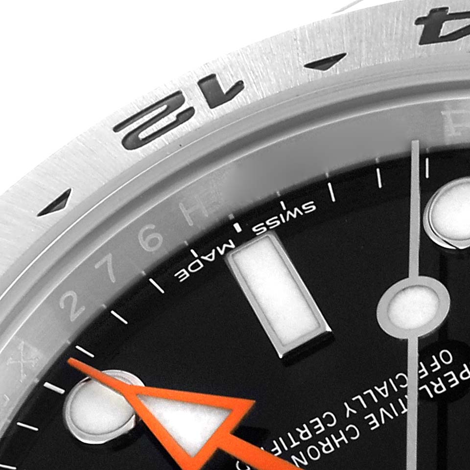 The image shows a close-up of the bezel, part of the dial, and the hands, including the orange hand, of a Rolex Explorer 216570 Men
s Stainless Steel Black Dial 216570 Men
s Stainless Steel Black Dial watch.