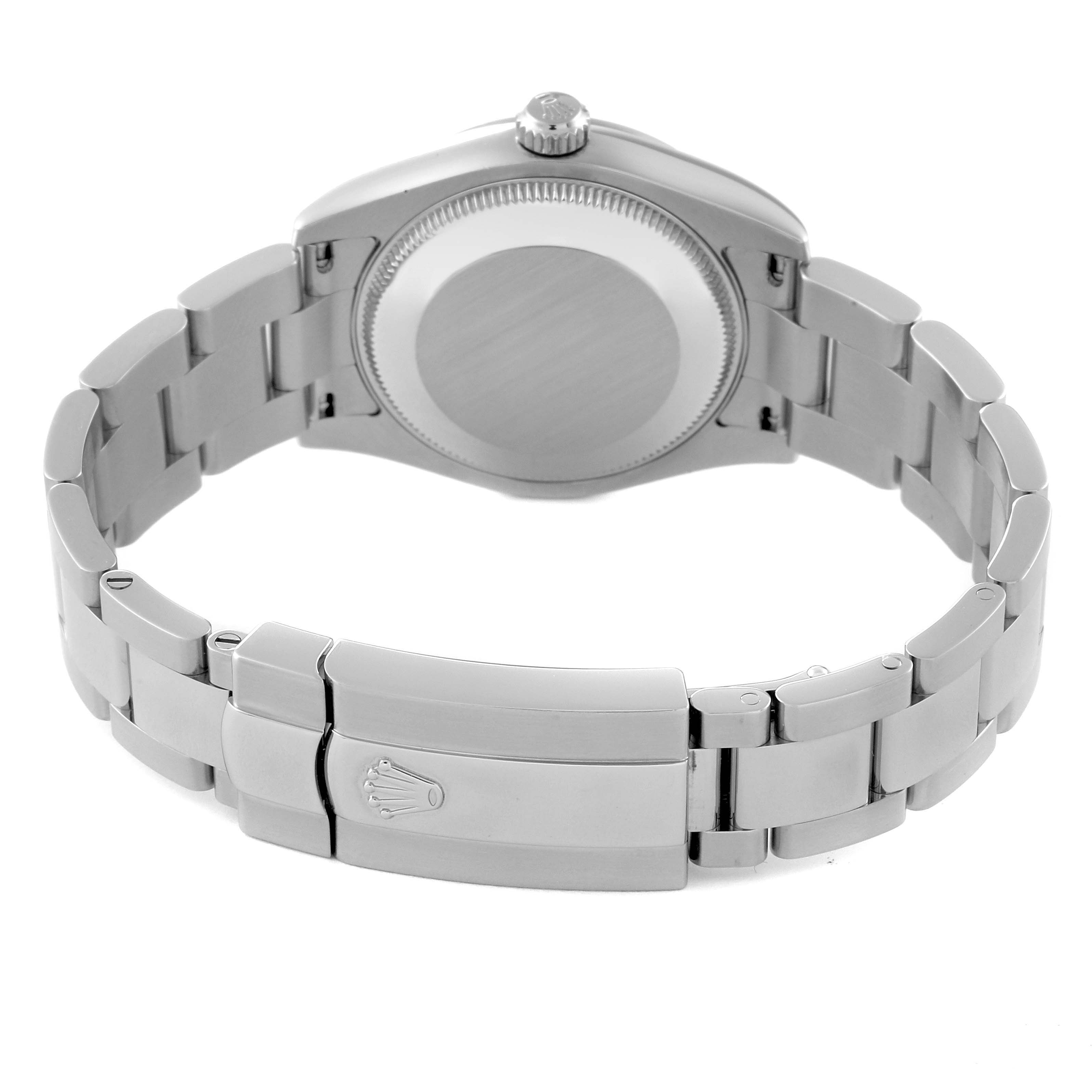 The image shows the back and clasp of a mid-size Rolex watch, featuring the case back and part of the bracelet.